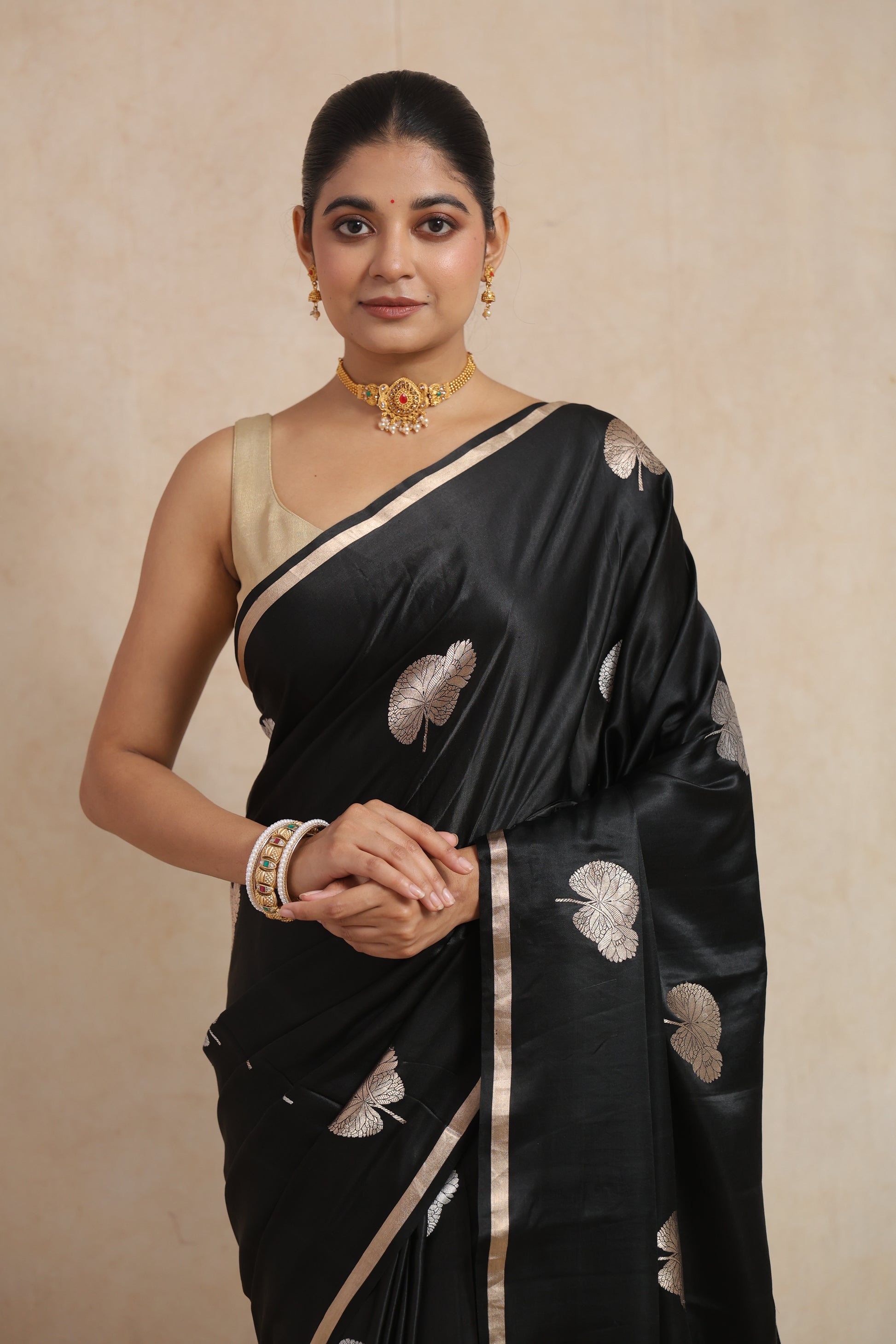 Portrait view of black Banarasi silk saree with silver woven motifs and sleek border