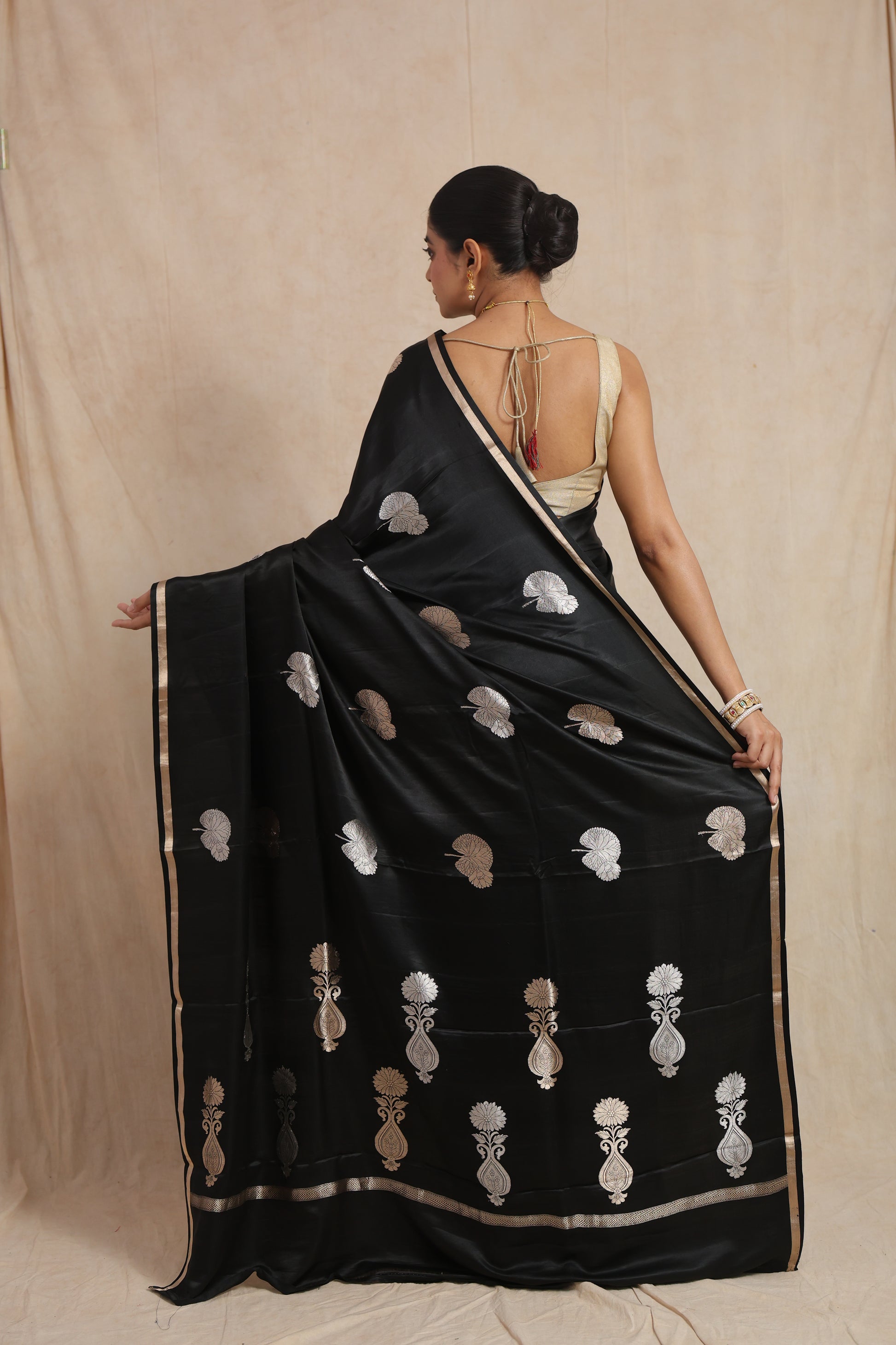 Back view of black Banarasi silk saree with silver woven motifs and elegant pallu