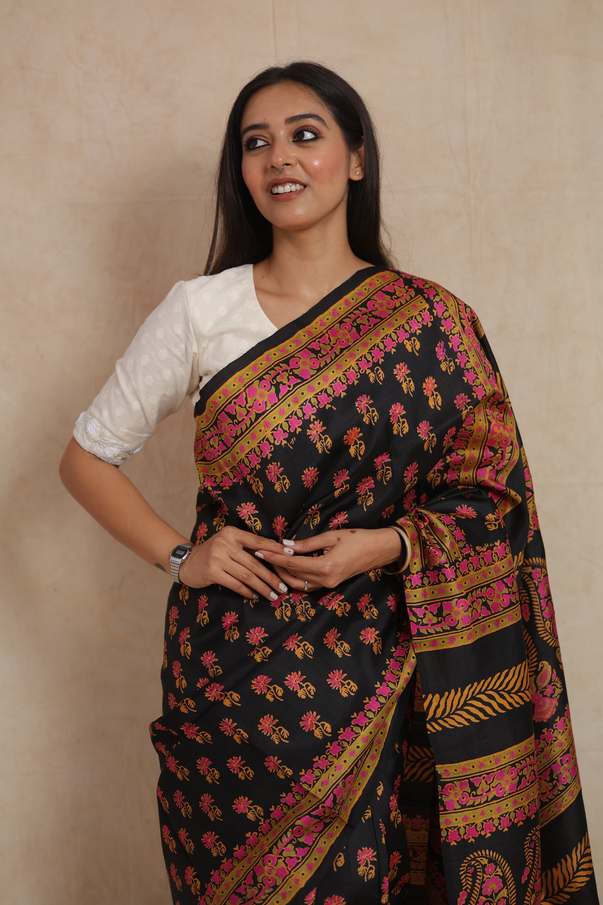 Close-up view of black Batik silk saree with floral buttas and pink border