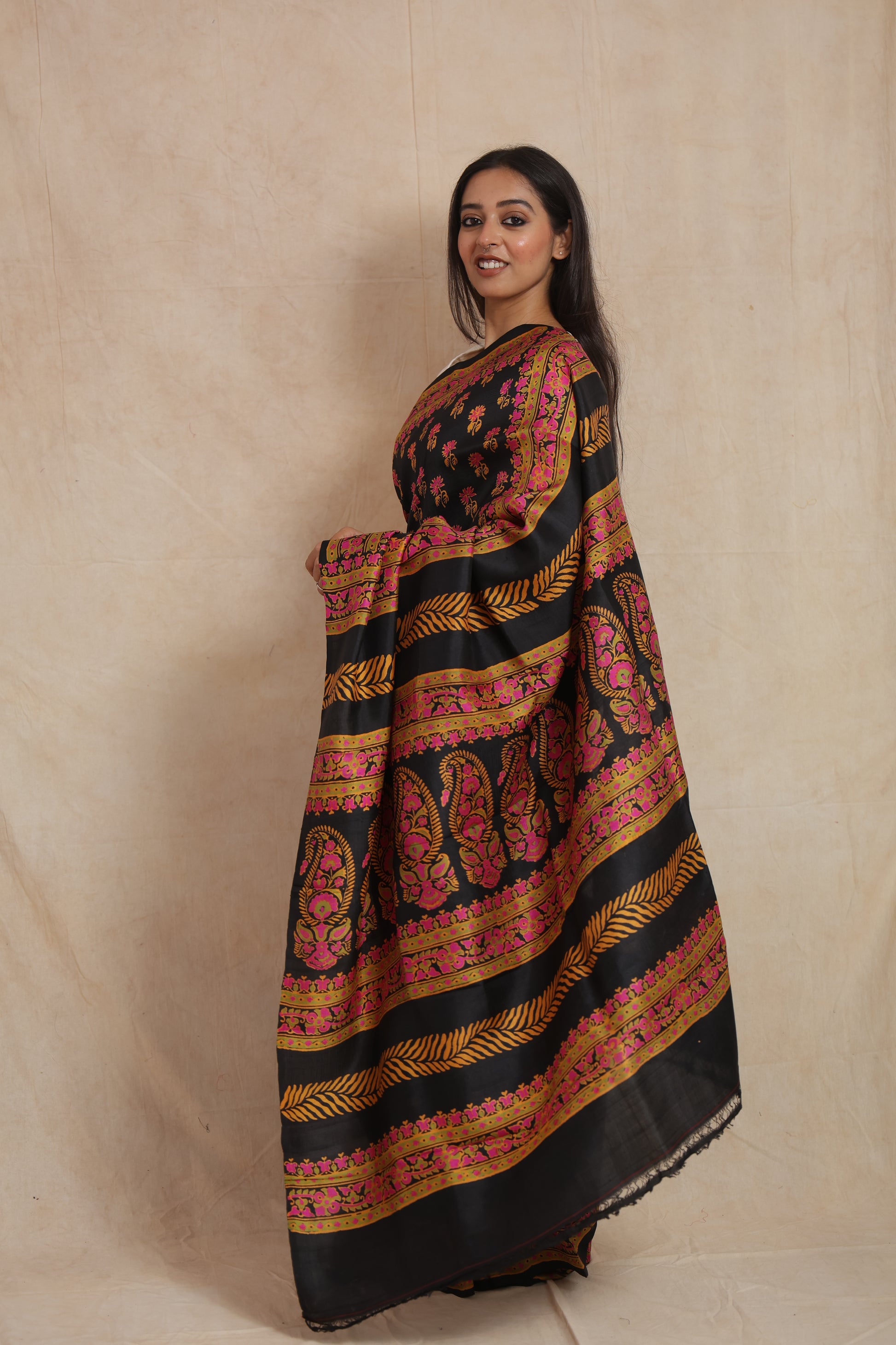 Side profile of black Batik silk saree with ornate paisley pallu