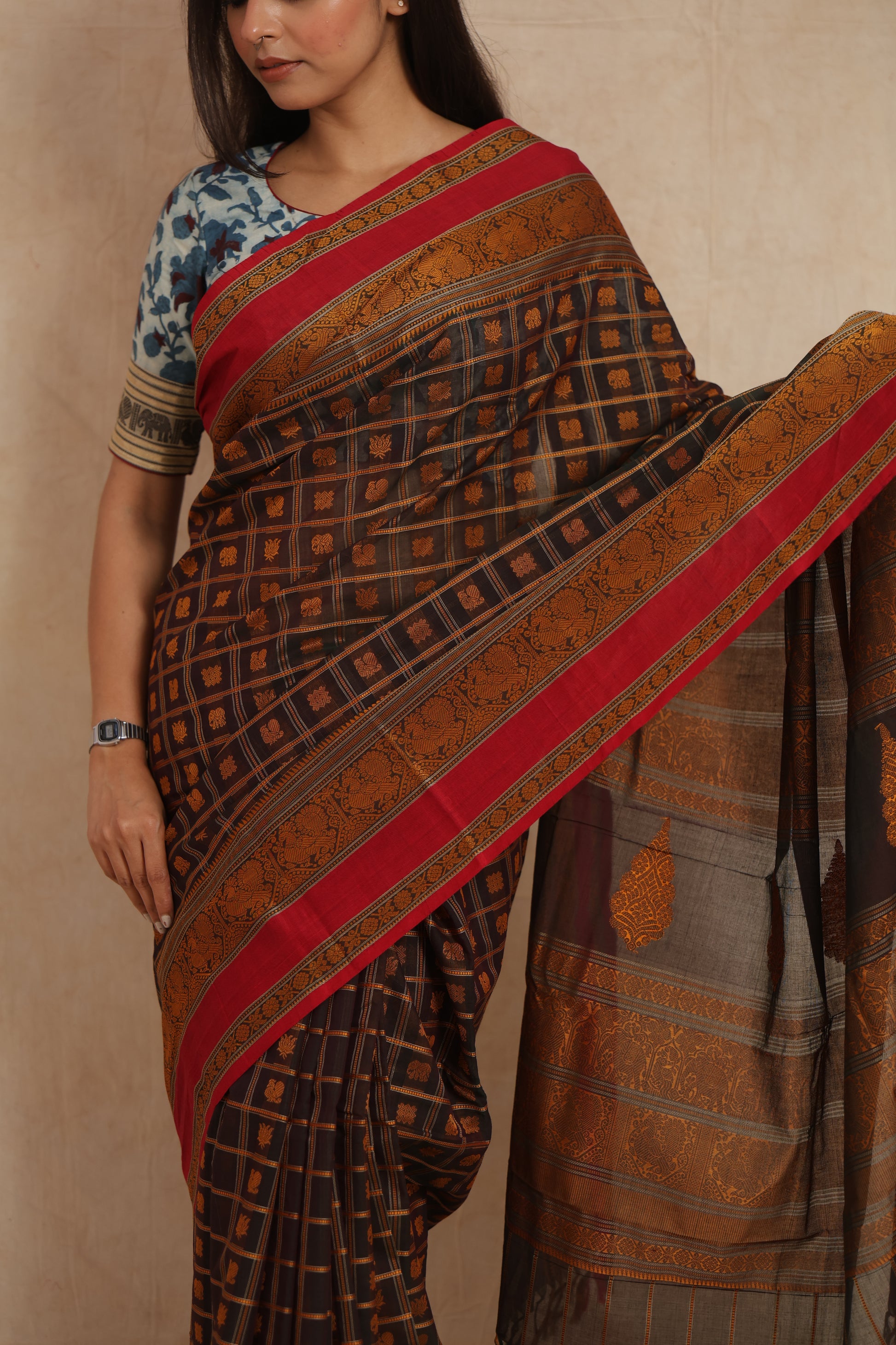 Close-up of black and copper Kanchipuram cotton saree with traditional woven motifs