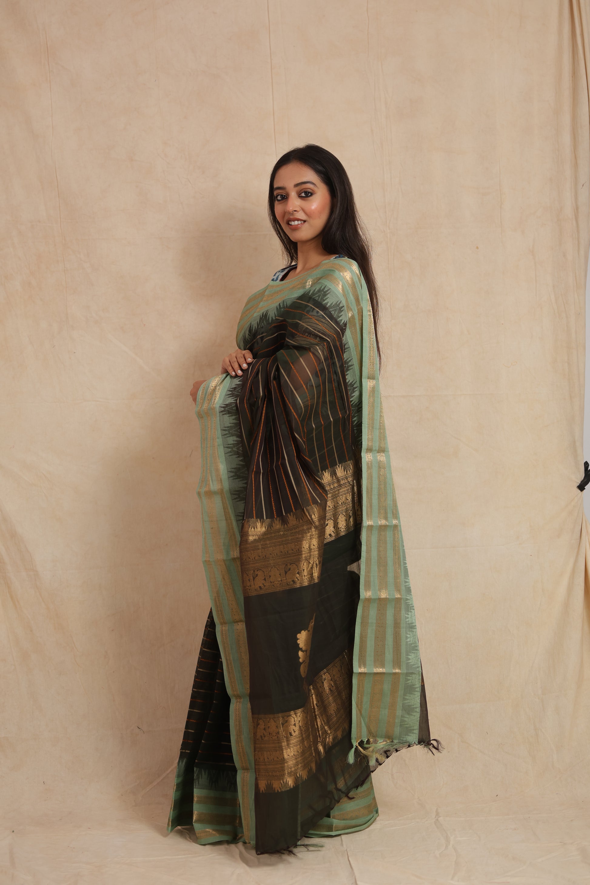 Side profile of black Kanchipuram cotton saree with elegant striped weave