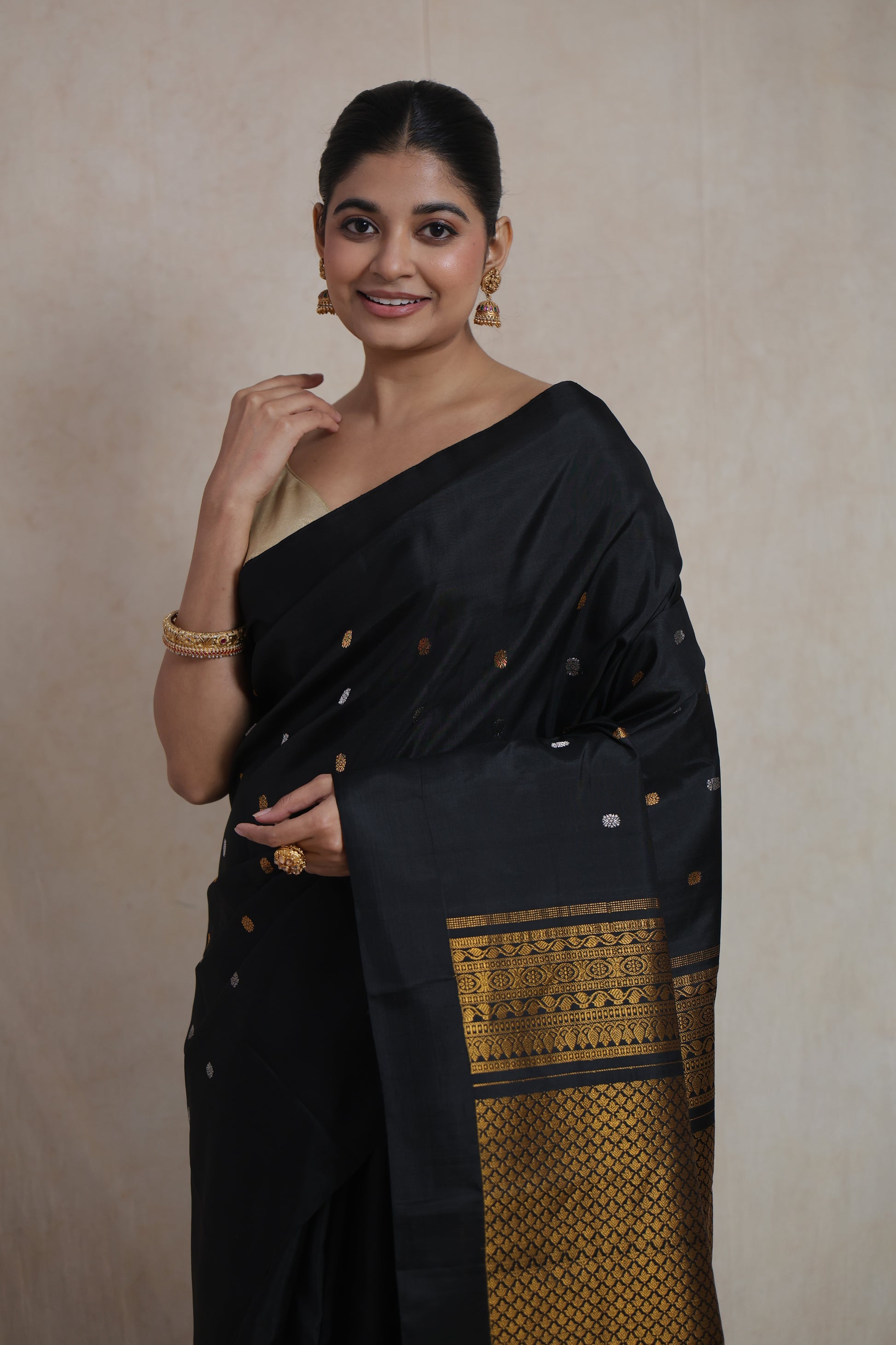 Portrait of black Gadwal silk saree with intricate gold woven border