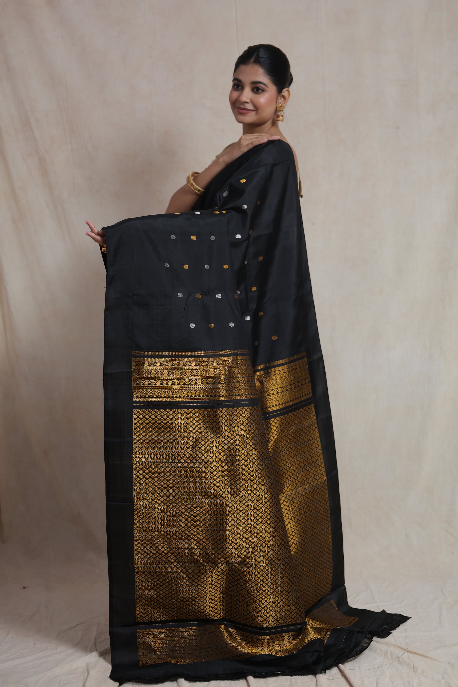 Back view of black Gadwal silk saree with rich gold woven pallu