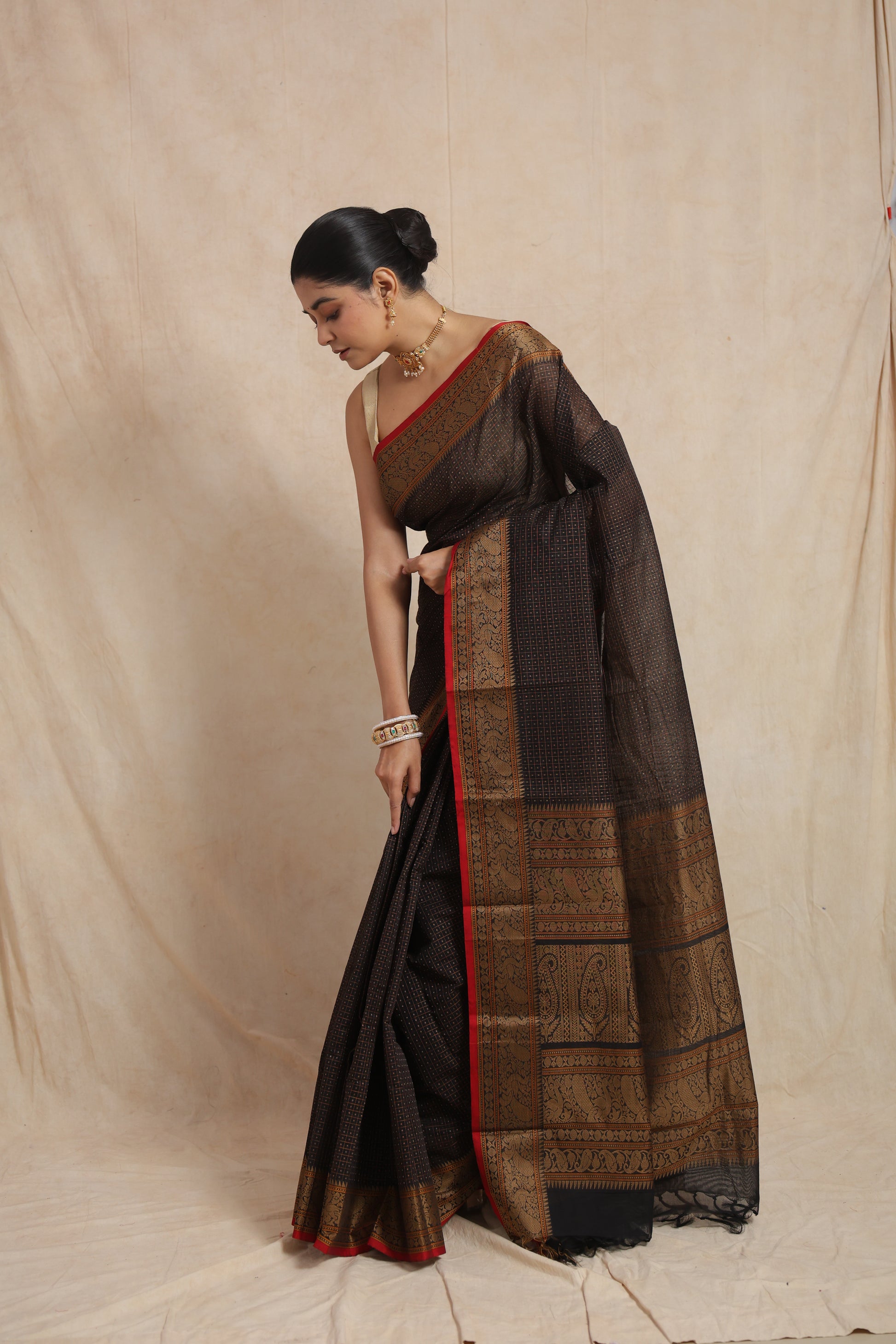 Classic black Kanchipuram cotton saree with antique woven motifs