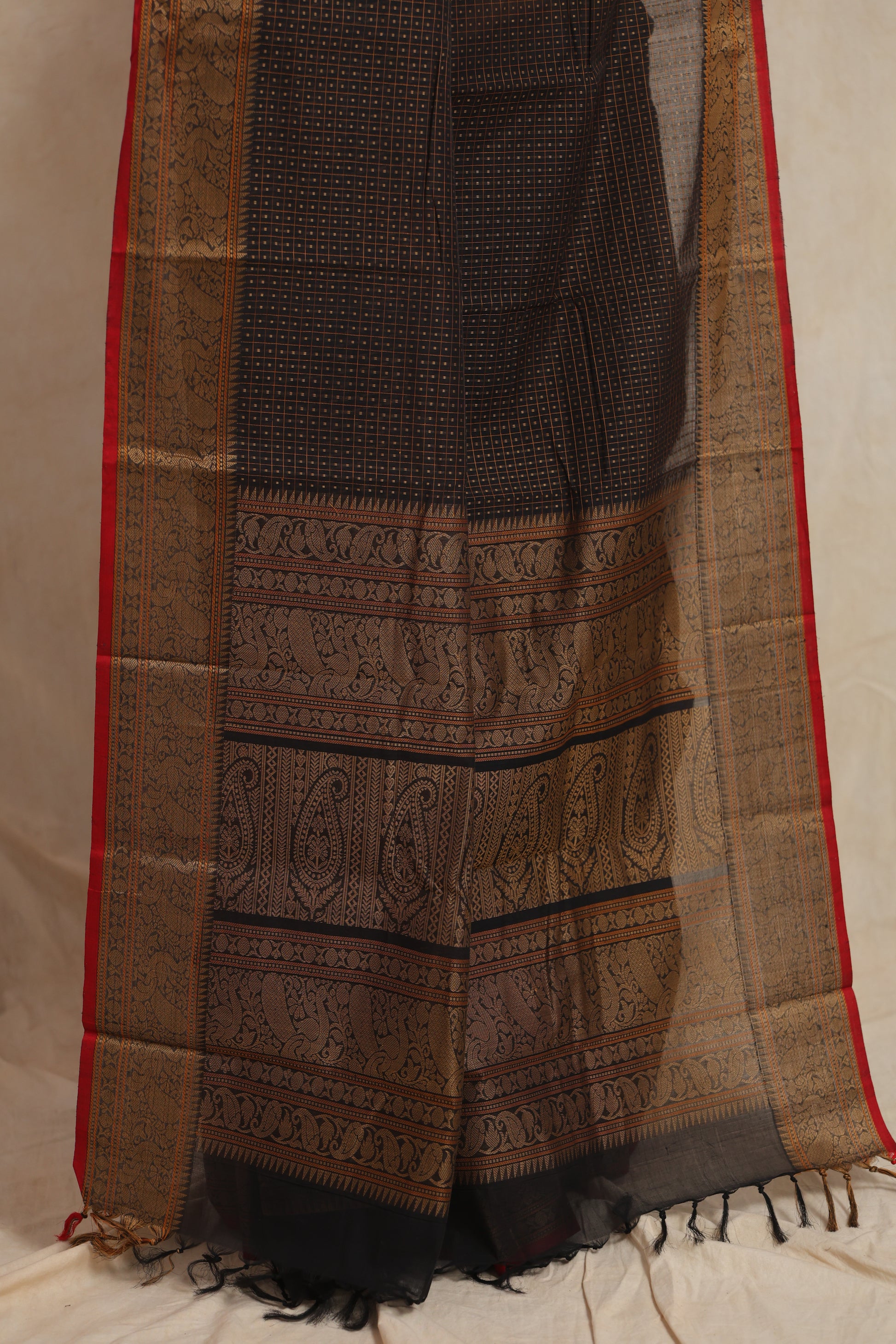 Detailed drape and border view of black Kanchipuram cotton saree