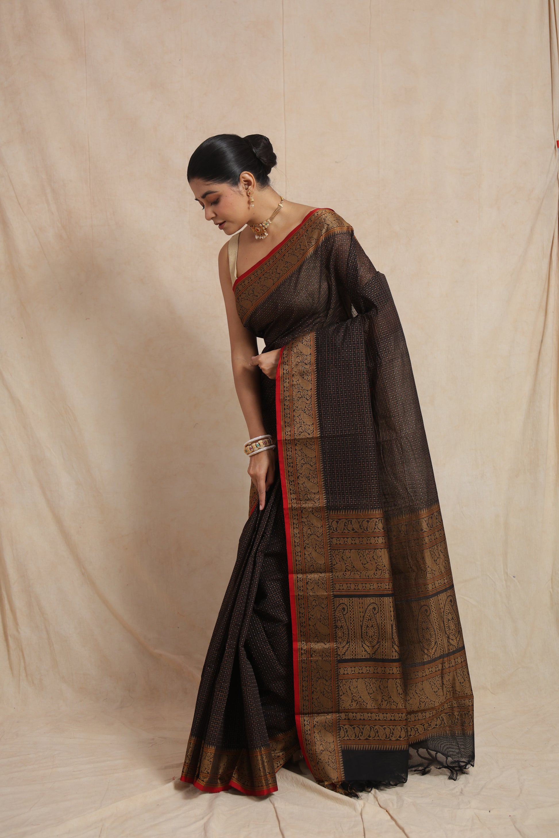 Side drape view of black Kanchipuram cotton saree