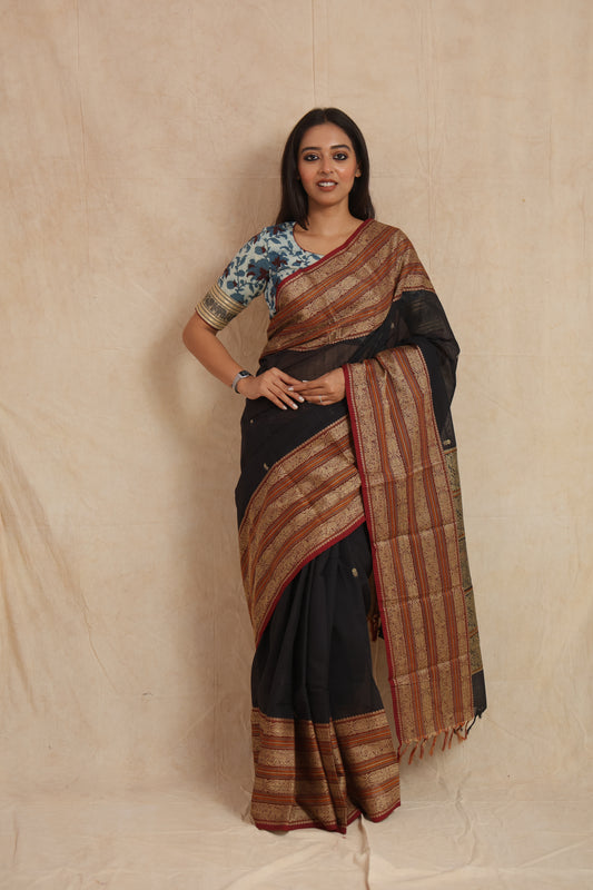 Model wearing black Kanchipuram handloom cotton saree with traditional woven border and detailed pallu