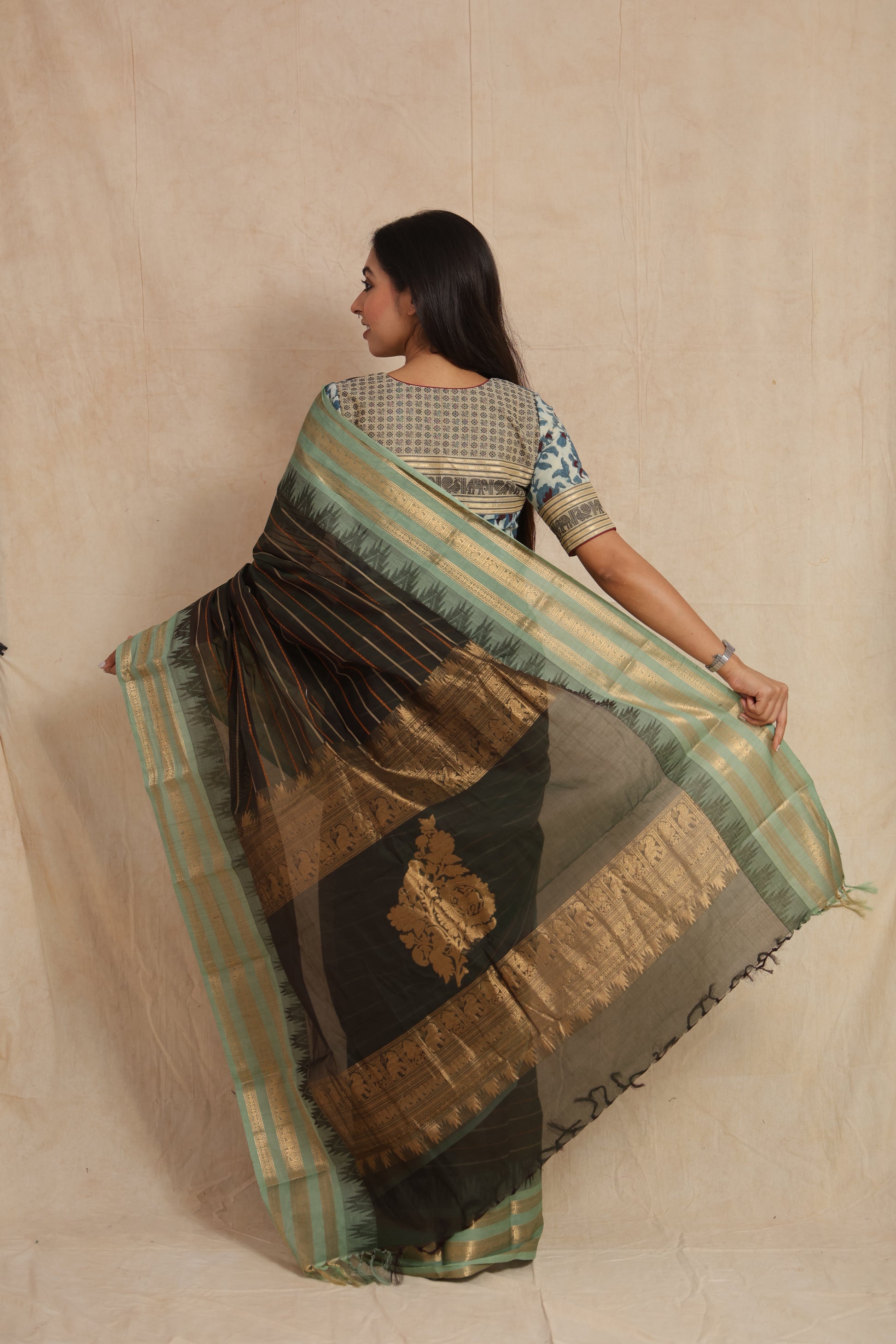 Back view of black Kanchipuram cotton saree showcasing traditional woven pallu