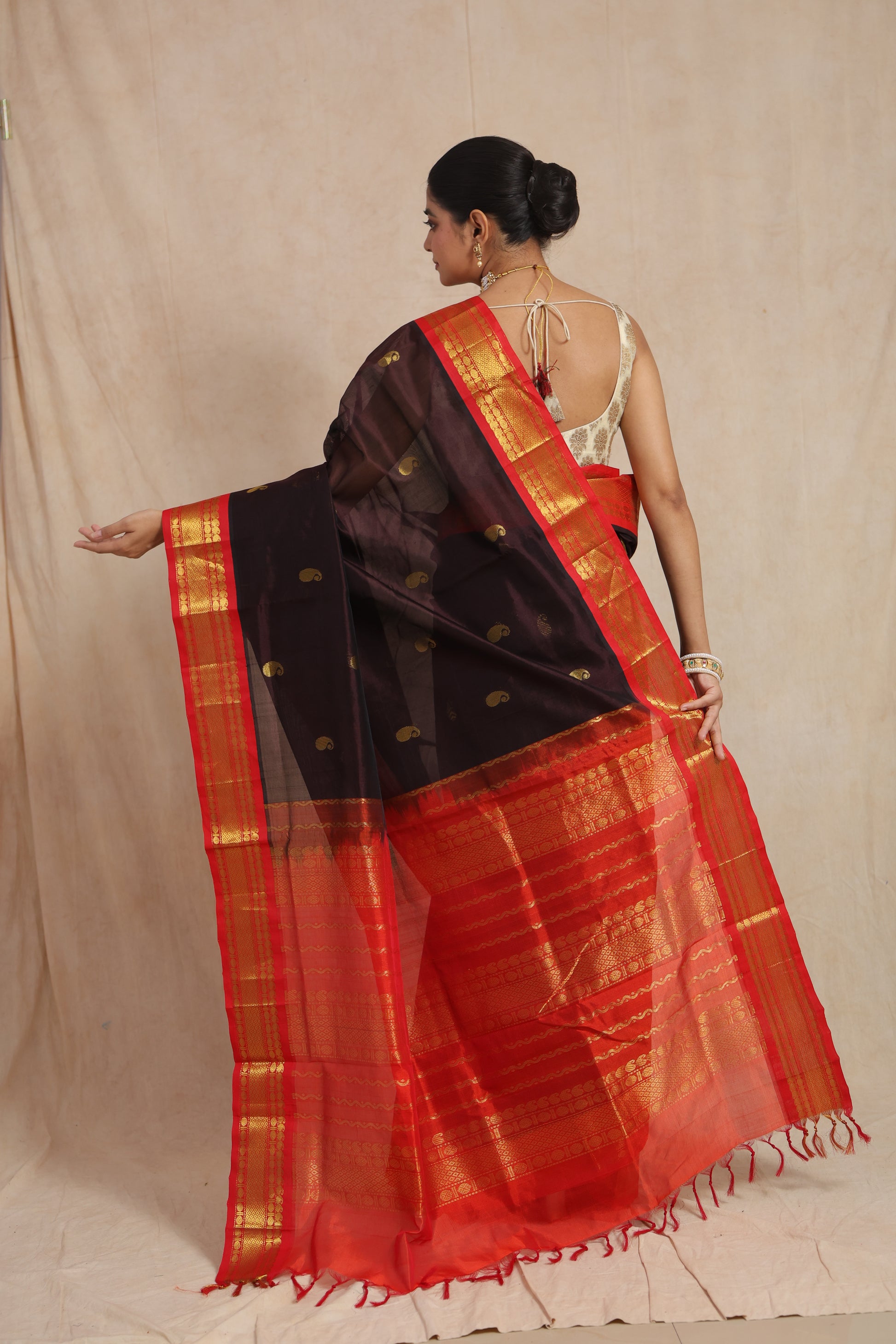 Detailed pallu of black Kanchipuram Sico saree with traditional golden zari weaving