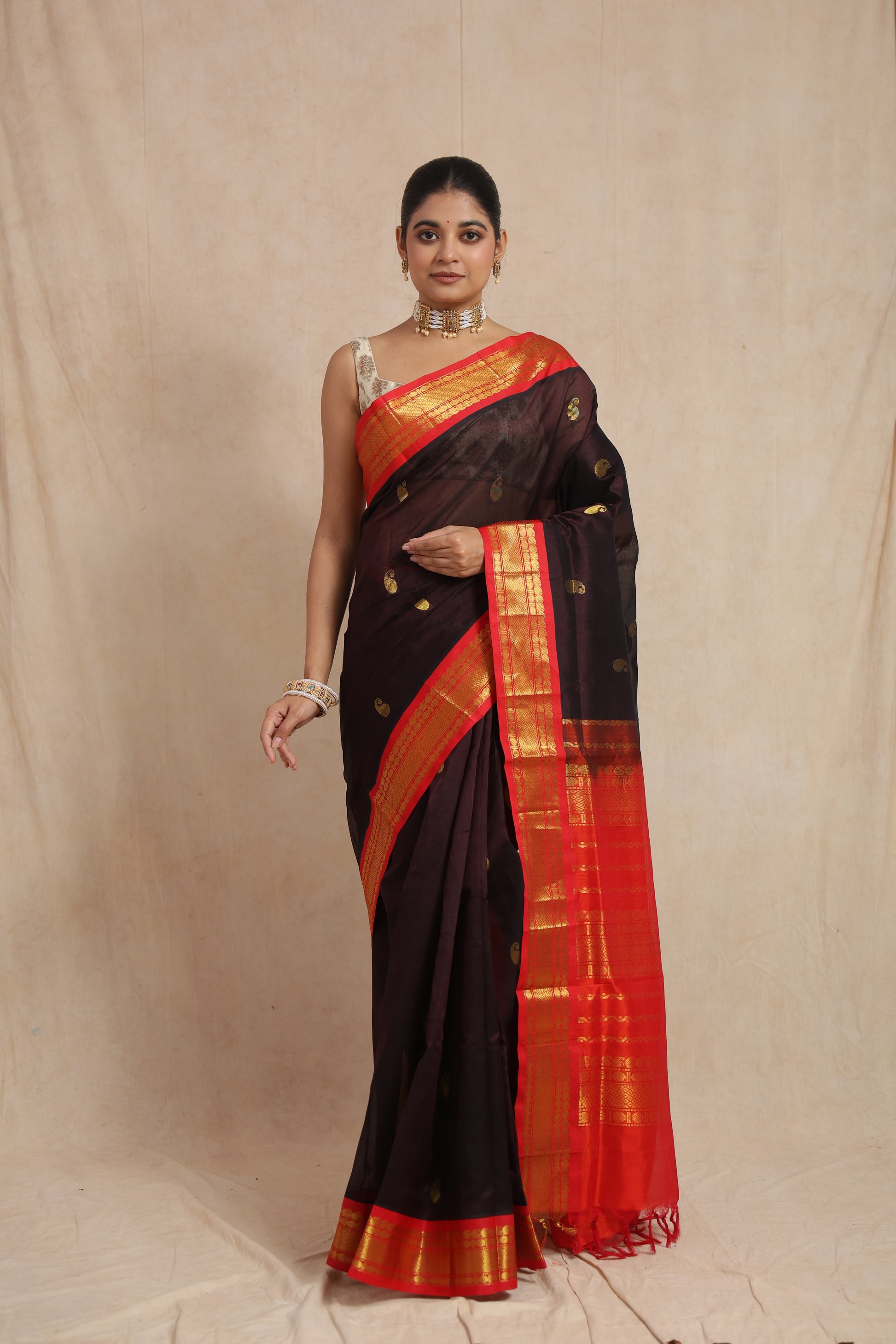 Elegant front drape of black Kanchipuram Sico saree with contrast red border