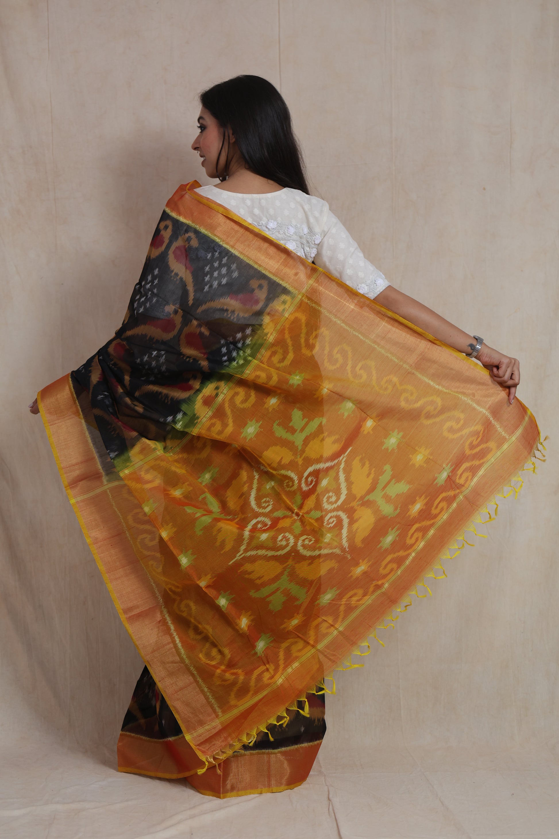 Back view of black and orange Panchampali handloom silk cotton saree with intricate Ikat woven pallu