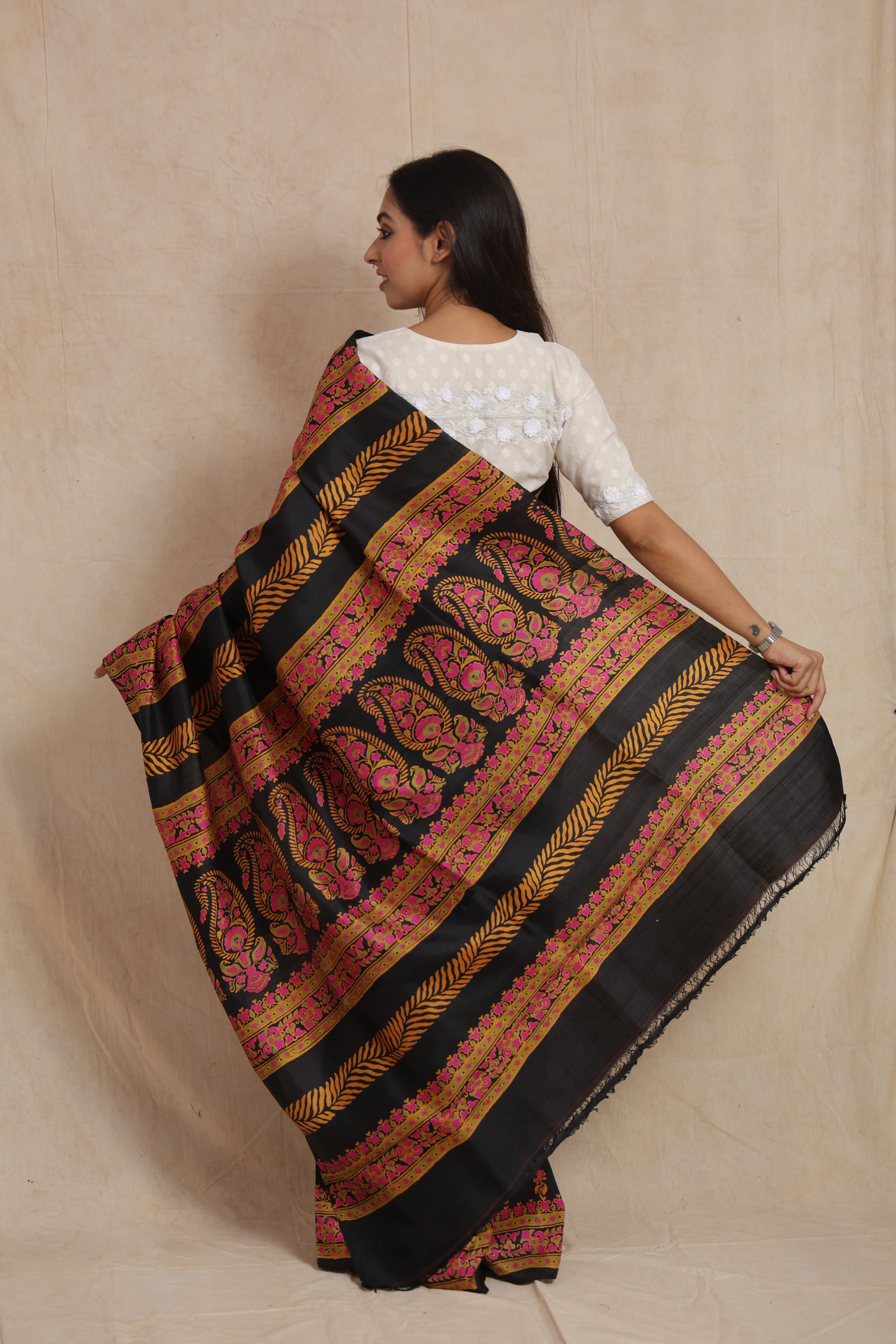 Back pallu view of black Batik silk saree with artistic paisley design