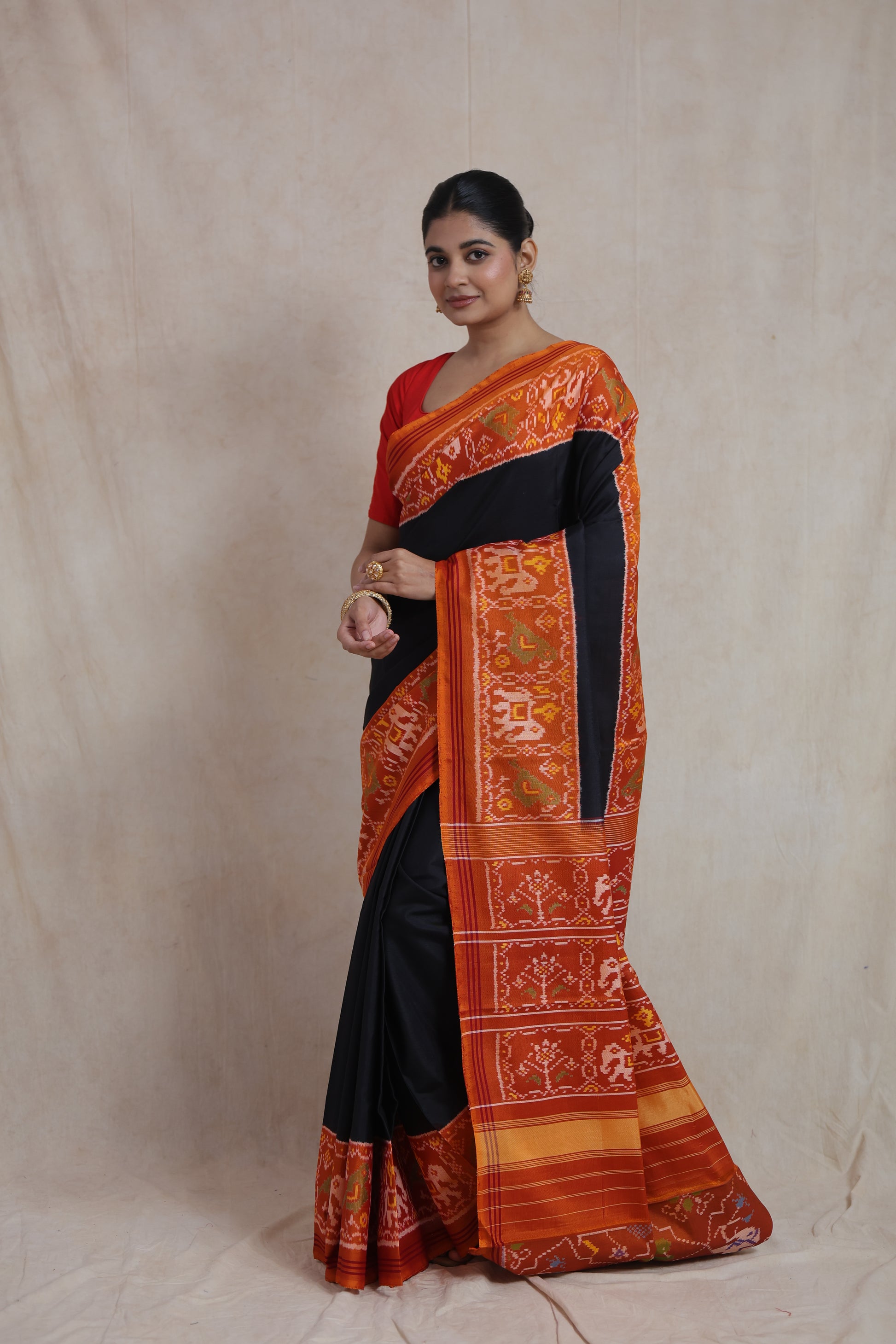 Full-length view of elegant black Patola silk saree with traditional weaving