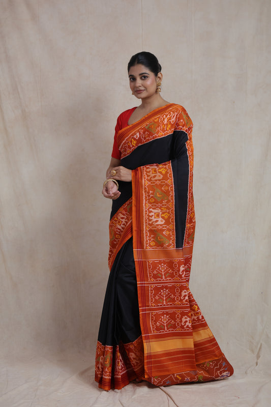 Full-length view of elegant black Patola silk saree with traditional weaving