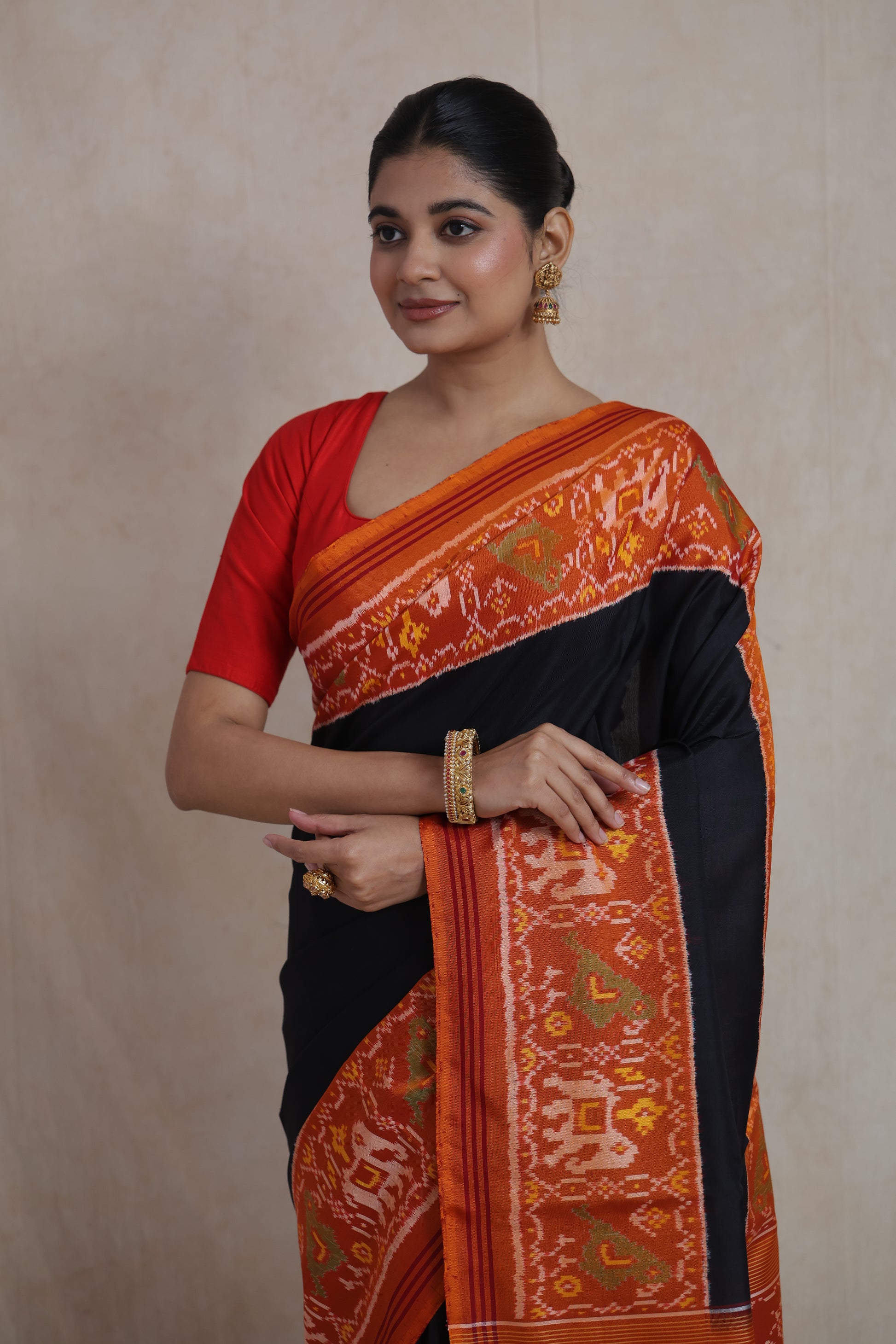 Elegant portrait look in black Patola silk saree with vibrant woven border