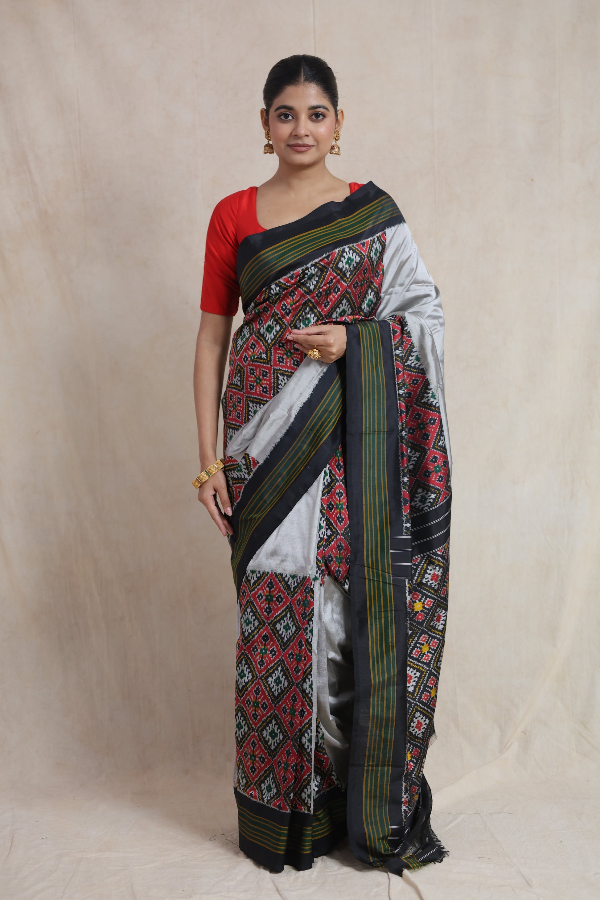 Full view of black and silver Panchampali handloom silk saree featuring traditional ikat motifs and striped border
