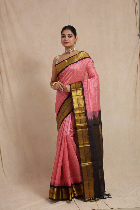 Full view of blush pink Kanchipuram Sico saree with antique gold woven border