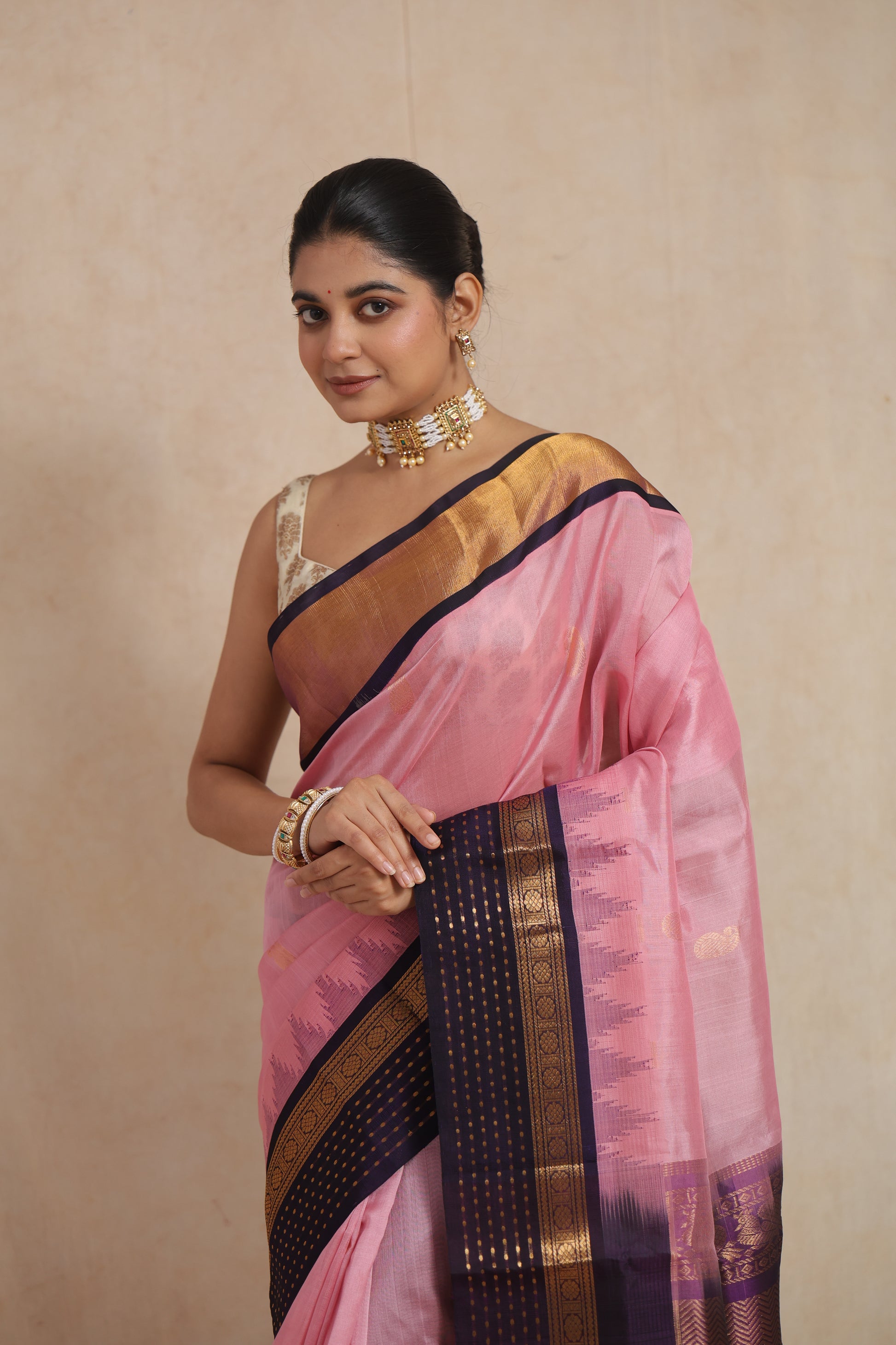 Elegant portrait of blush pink Kanchipuram Sico saree with traditional zari detailing