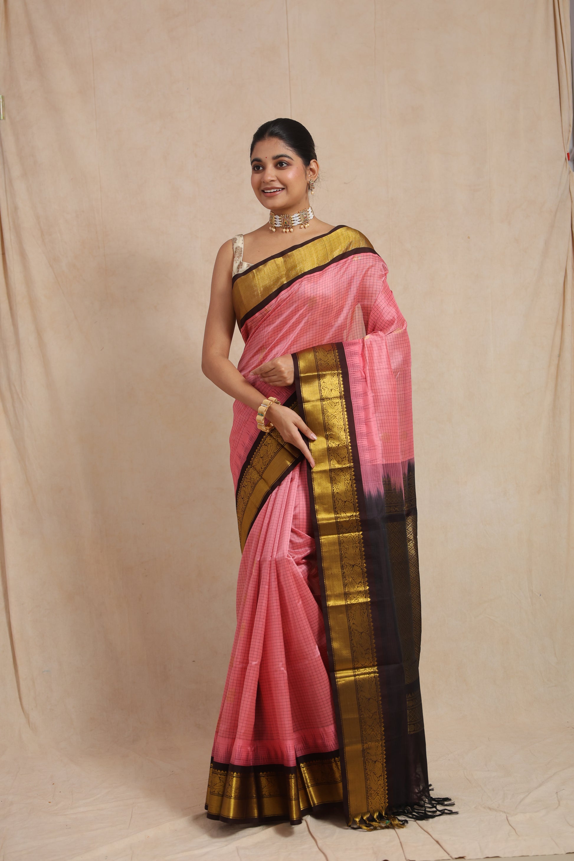 Traditional look featuring blush pink Kanchipuram Sico saree with rich contrast pallu