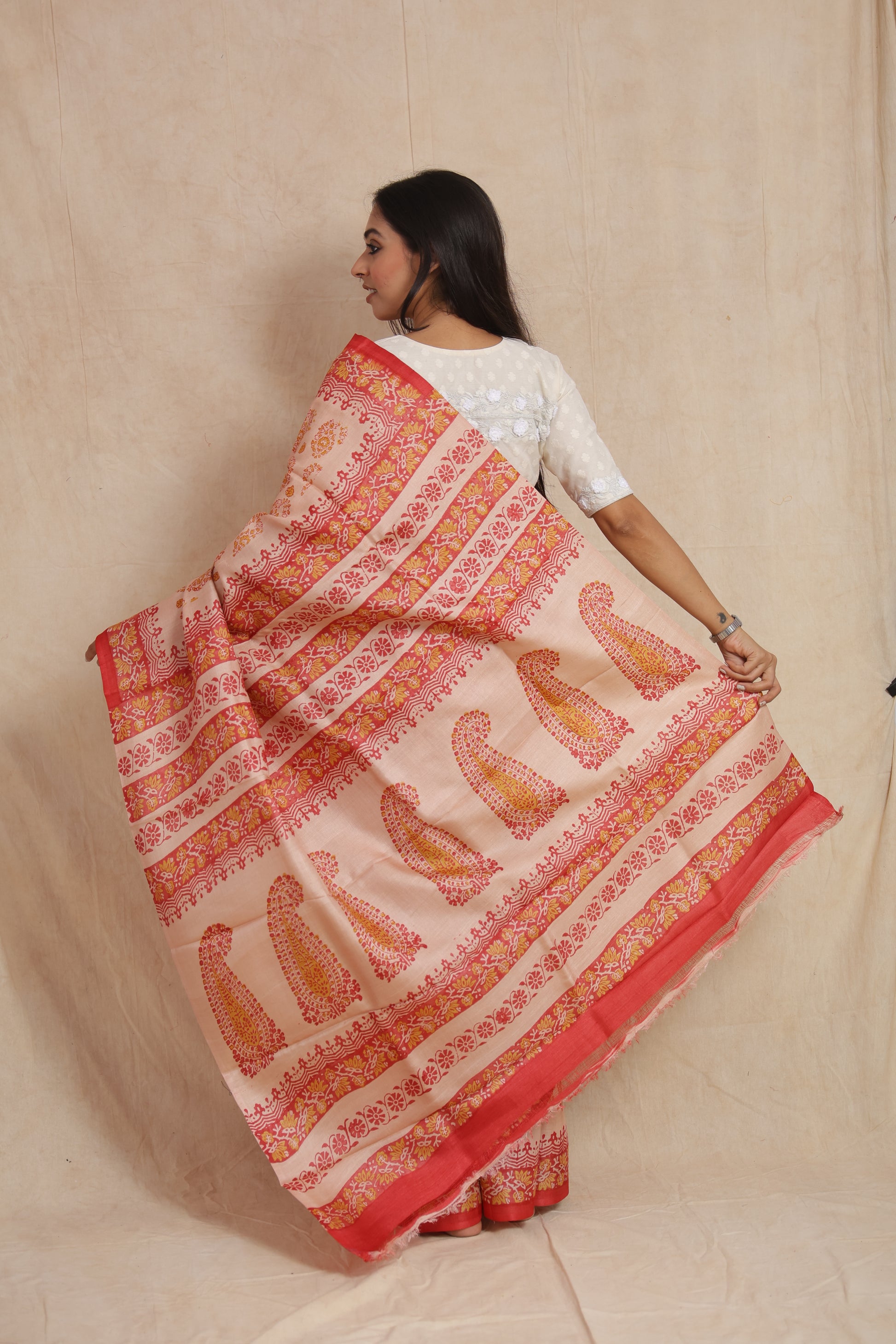 Back pallu view of blush pink Batik silk saree with paisley and floral printed design
