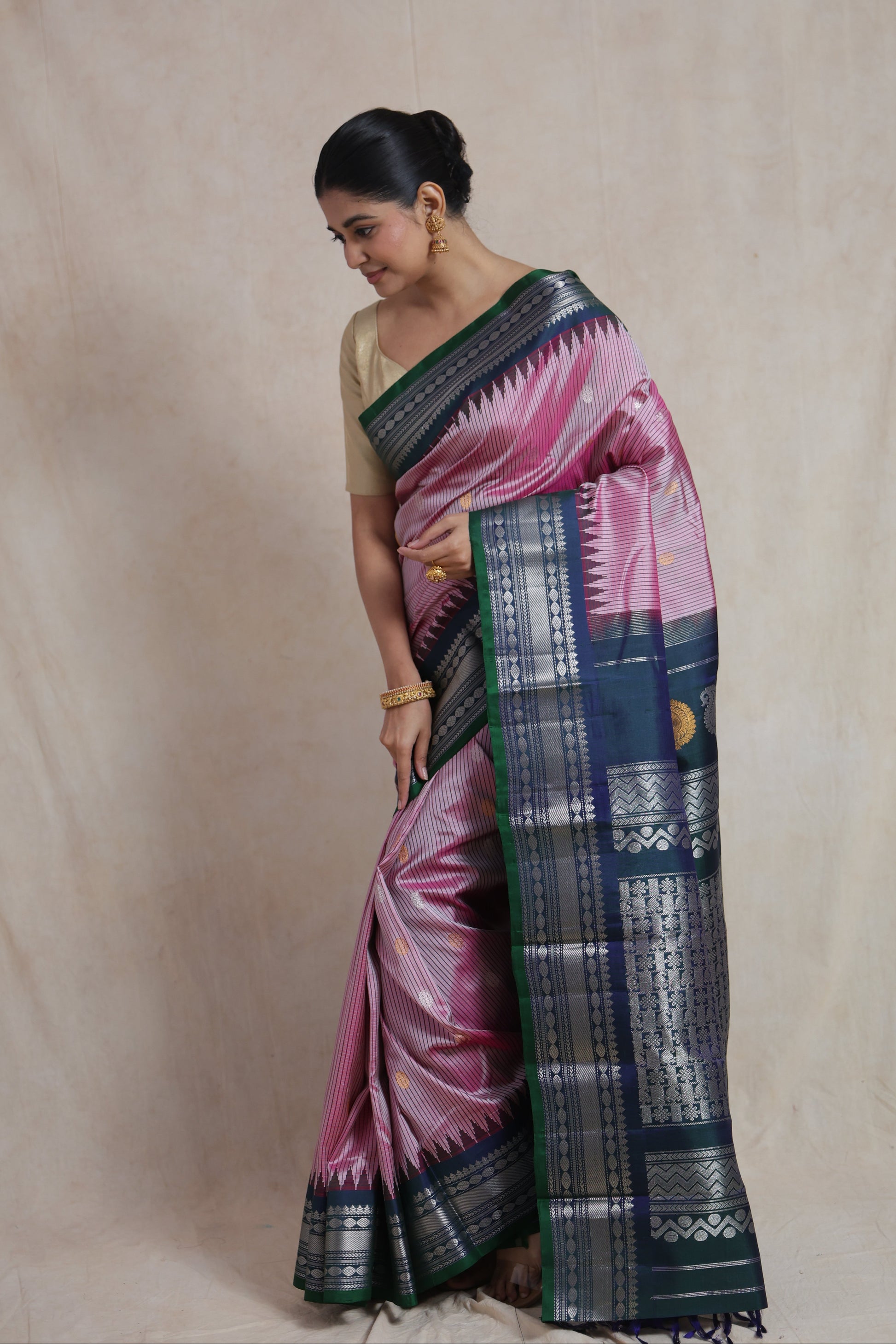 Side pose of blush pink Gadwal Silk saree with silver woven border