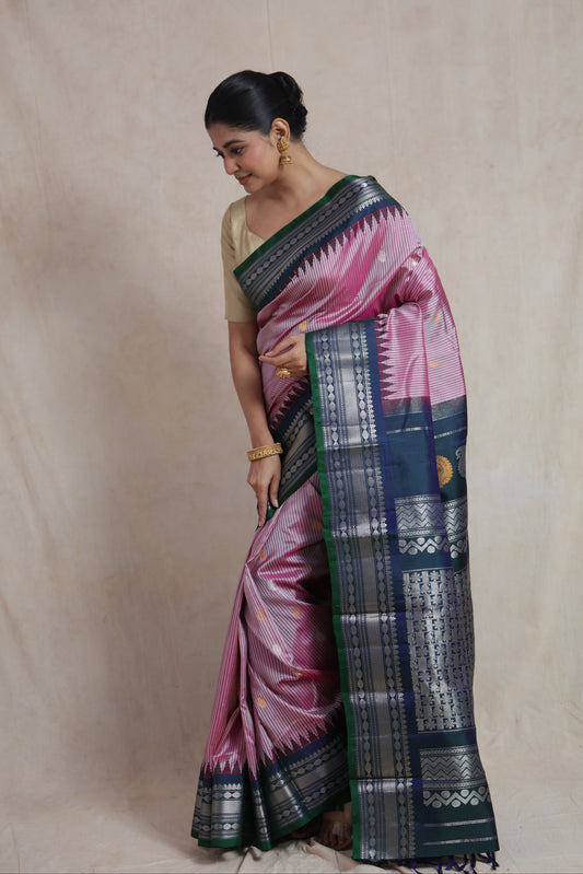 Side pose of blush pink Gadwal Silk saree with silver woven border