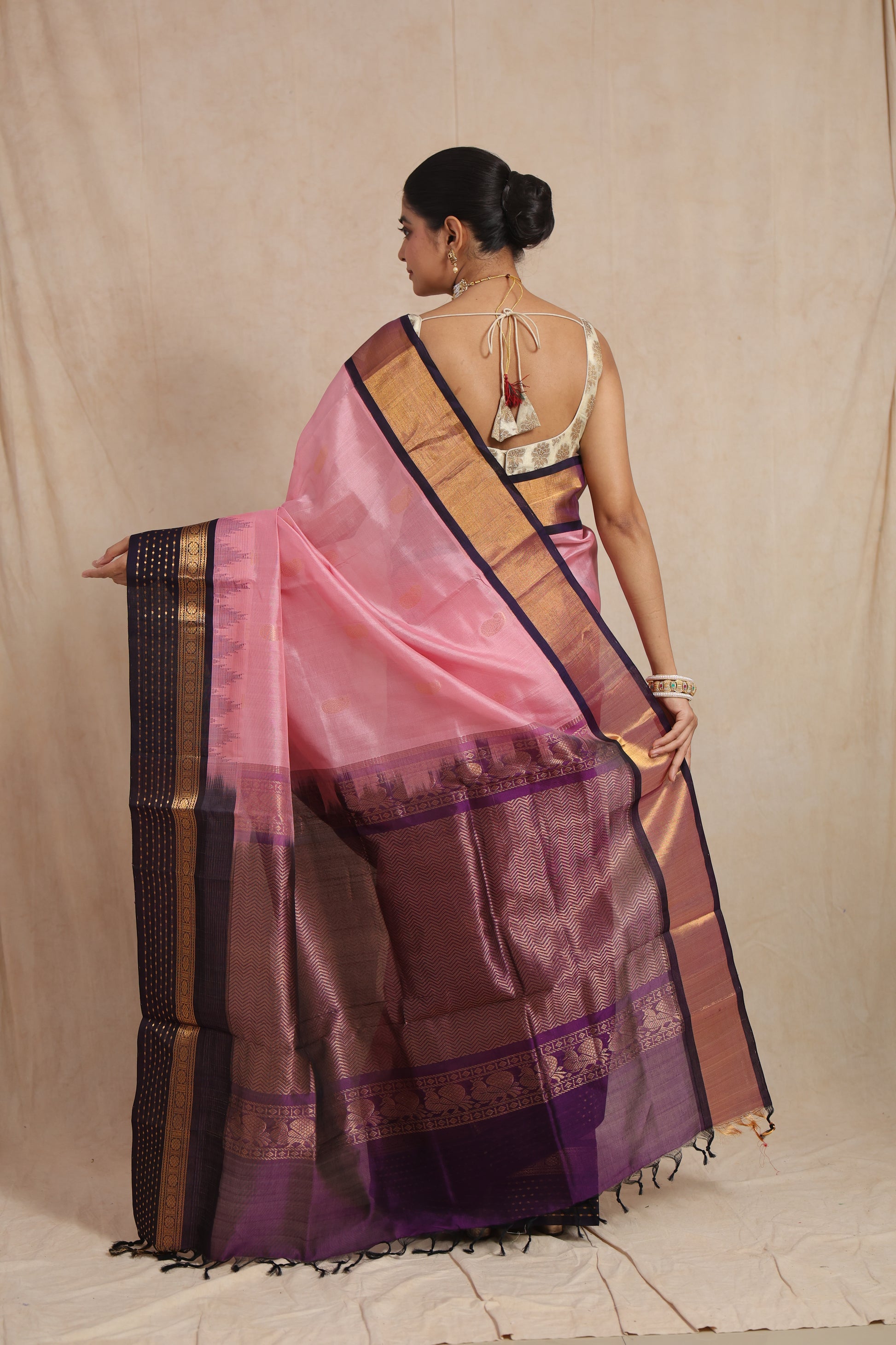 Back view of blush pink Kanchipuram Sico saree with deep purple zari pallu