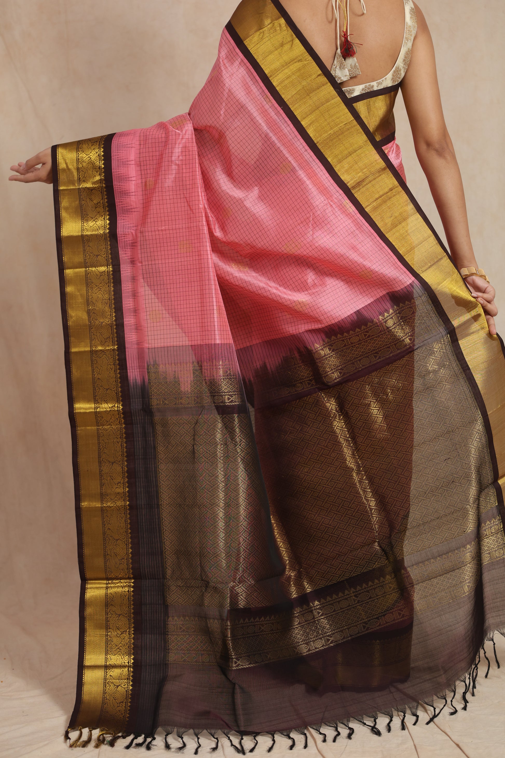 Back view of blush pink Kanchipuram Sico saree with rich woven pallu and tassels