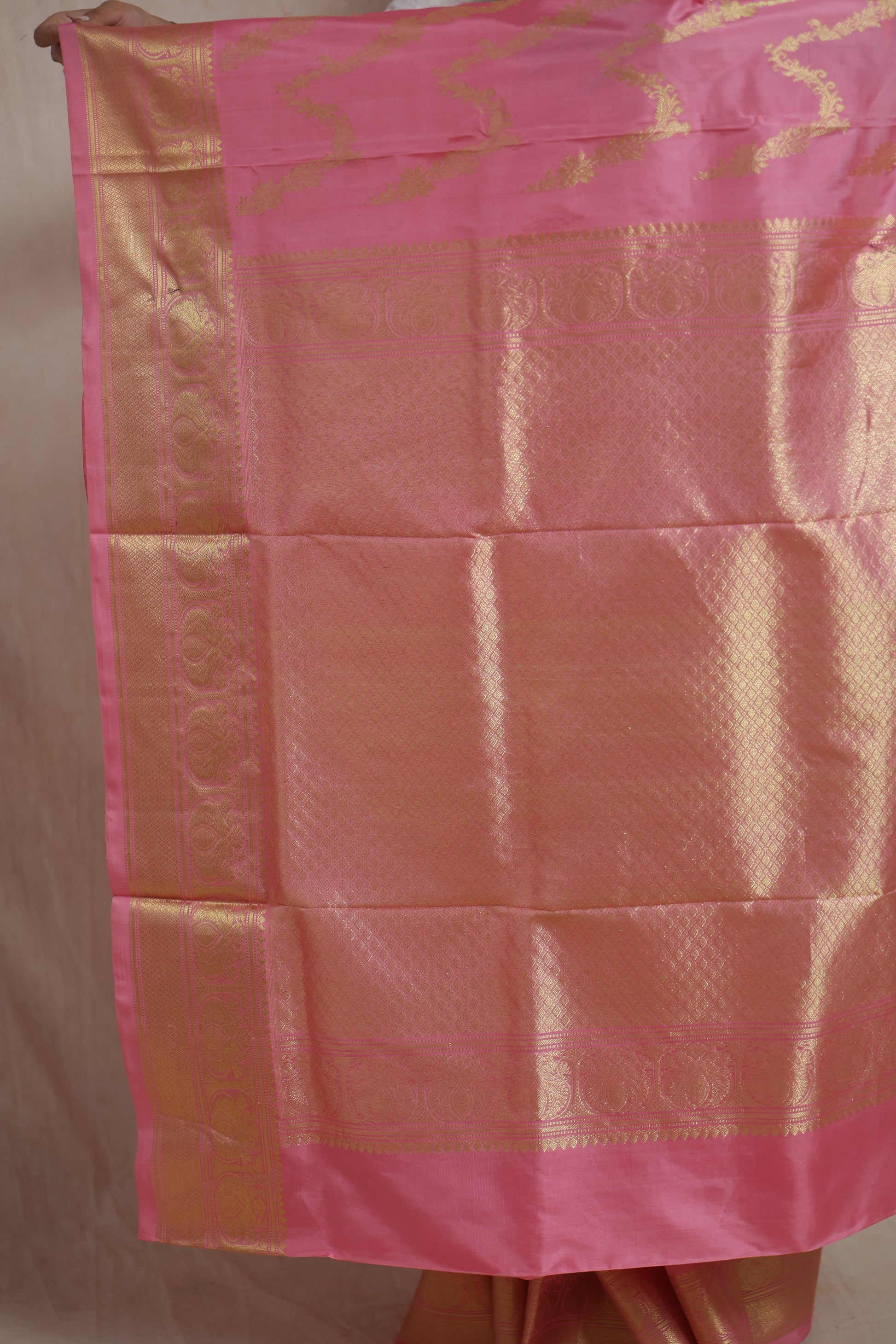 Close-up of richly woven gold pallu on blush pink Kanchipuram silk saree