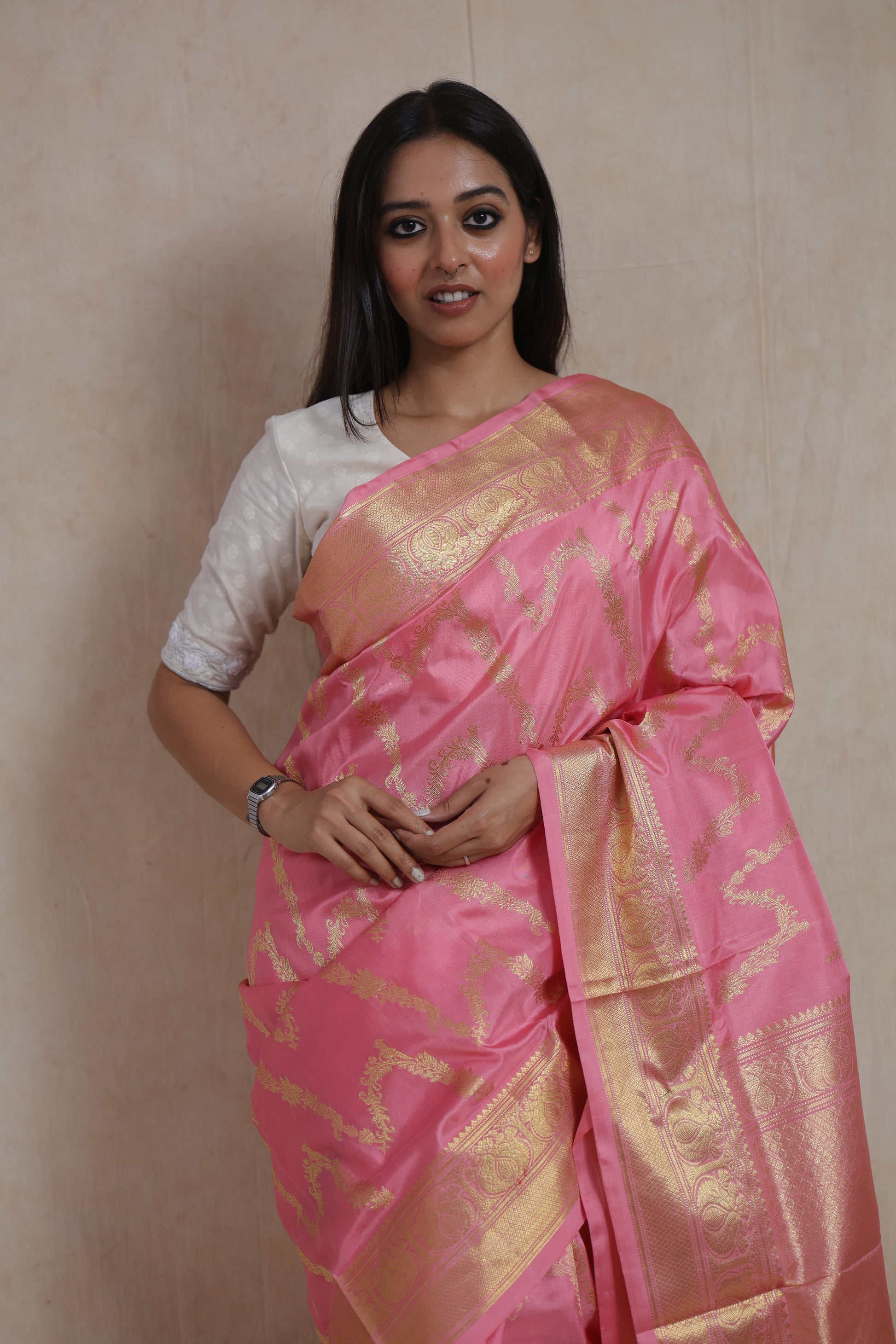 Portrait view of blush pink Kanchipuram silk saree with elegant gold border