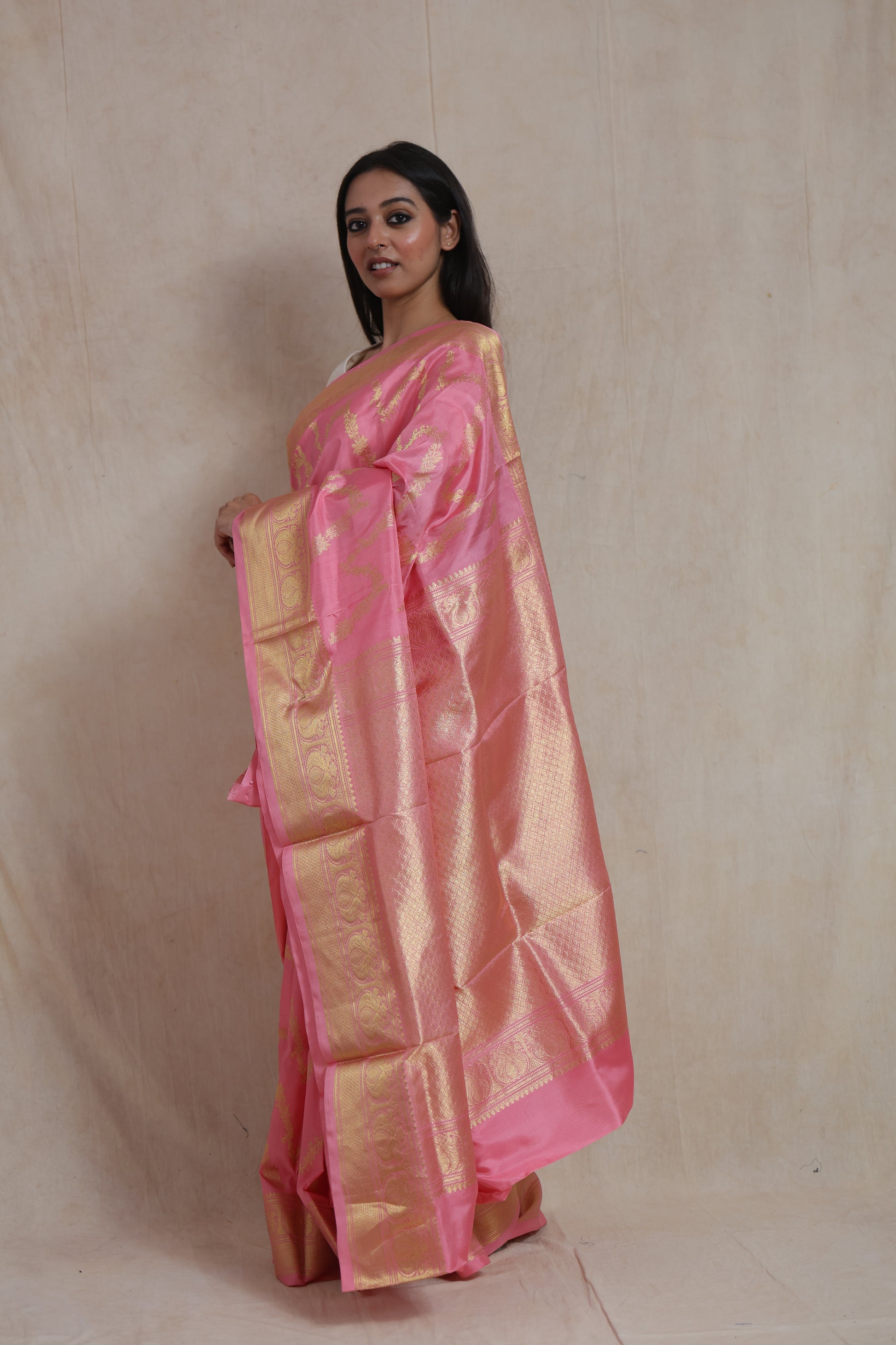 Side view of blush pink Kanchipuram silk saree with gold woven pallu
