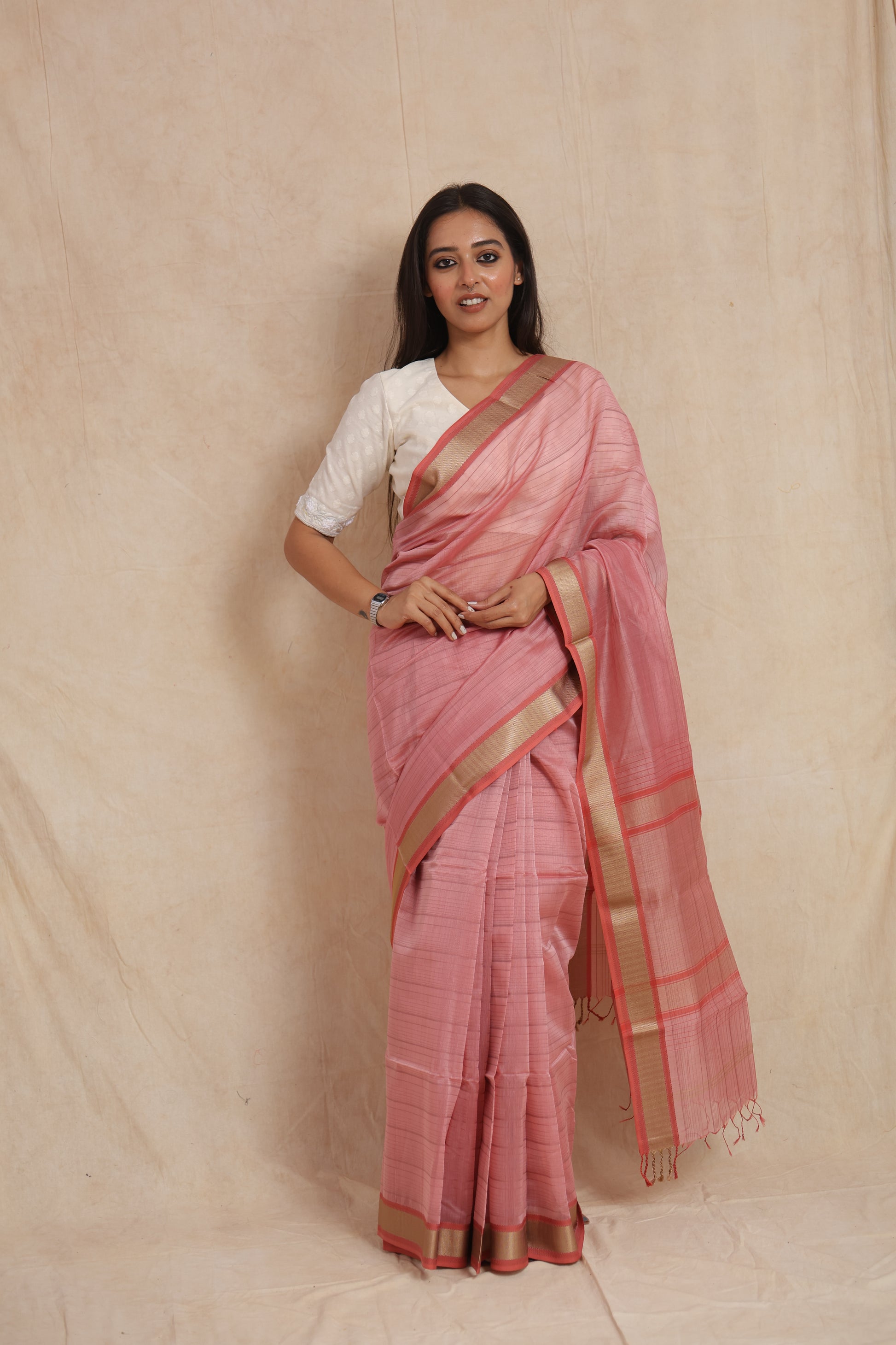 Front view of blush pink Maheshwari cotton saree with golden border