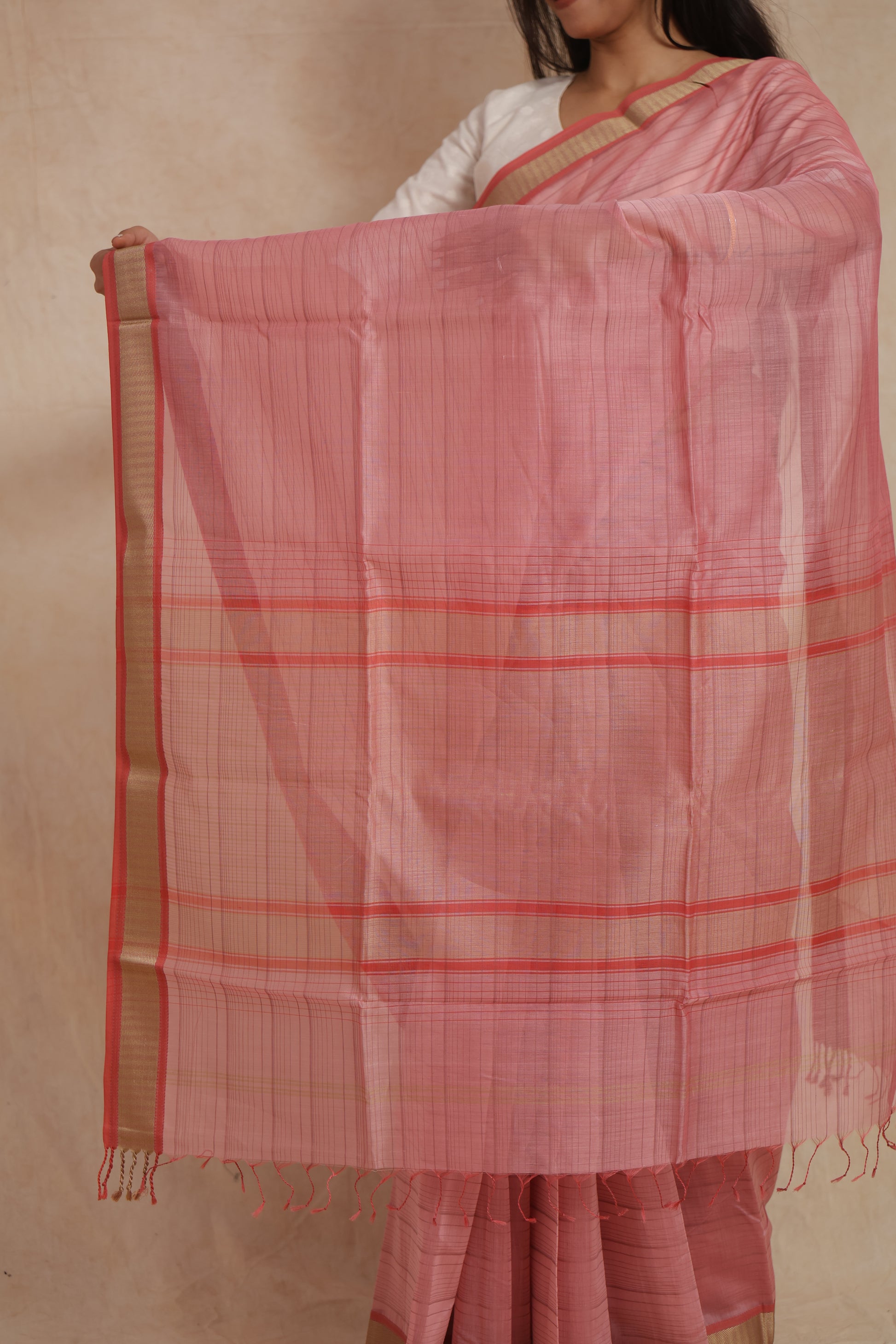 Close-up of woven pallu on blush pink Maheshwari cotton saree