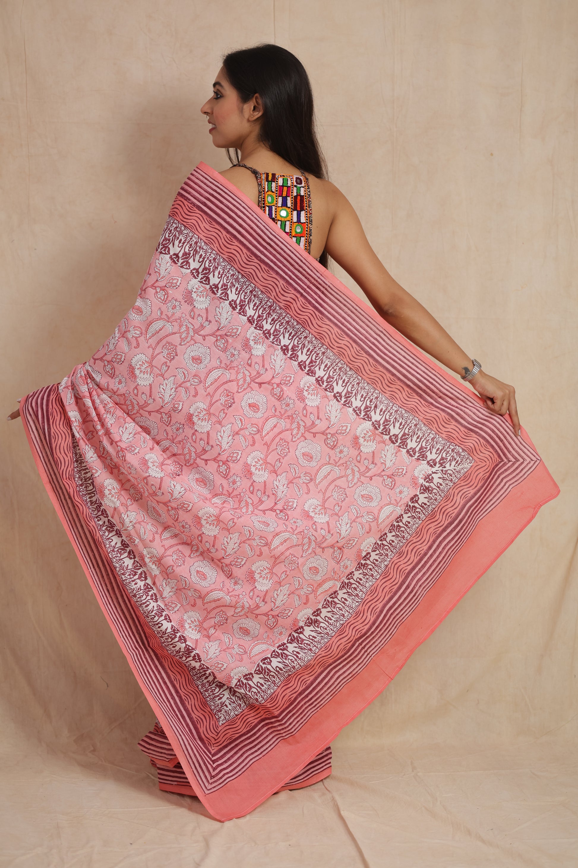 Back pallu display of blush pink Sanghnaree cotton saree with floral design
