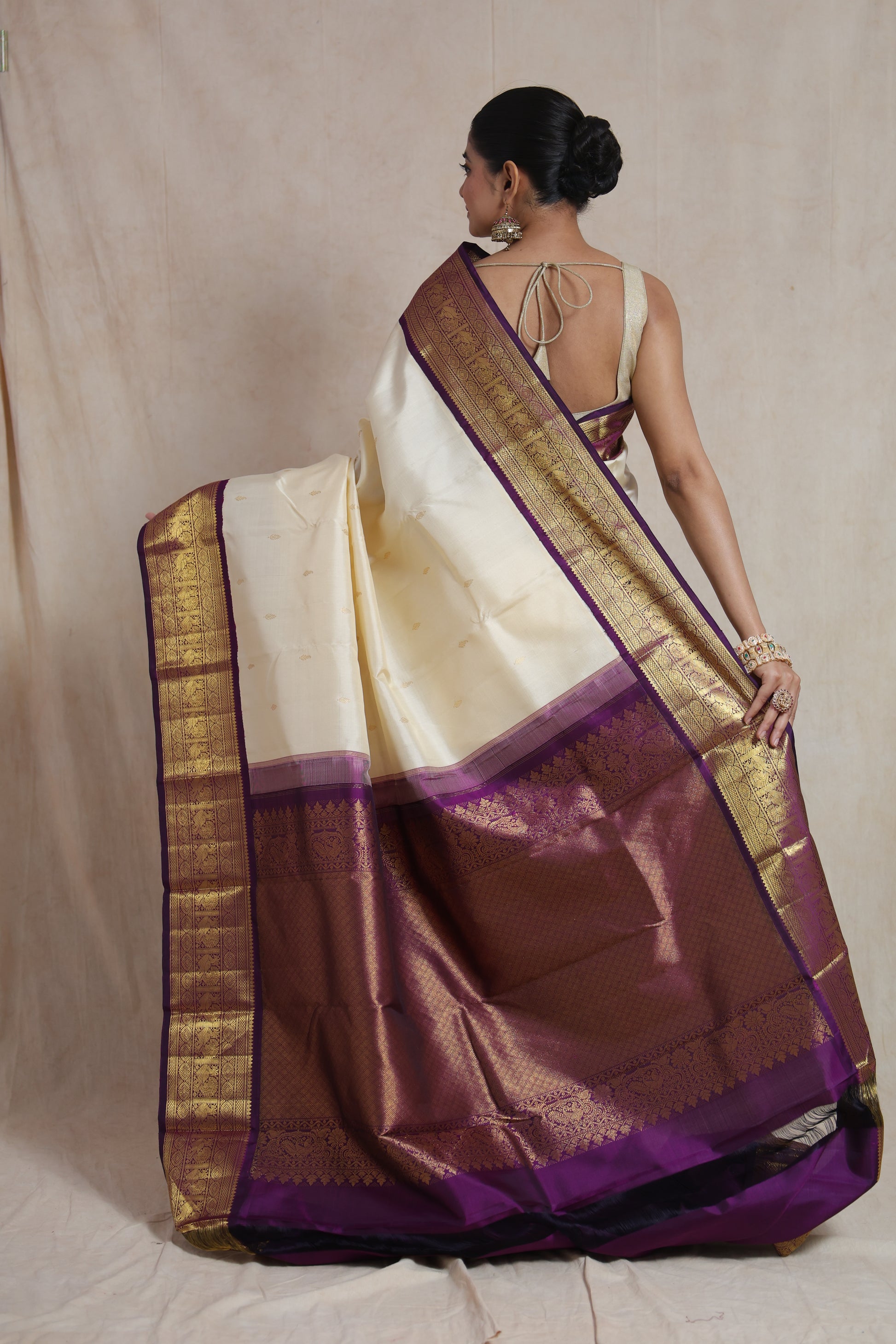 Back view of ivory Kanchipuram silk saree with royal purple pallu