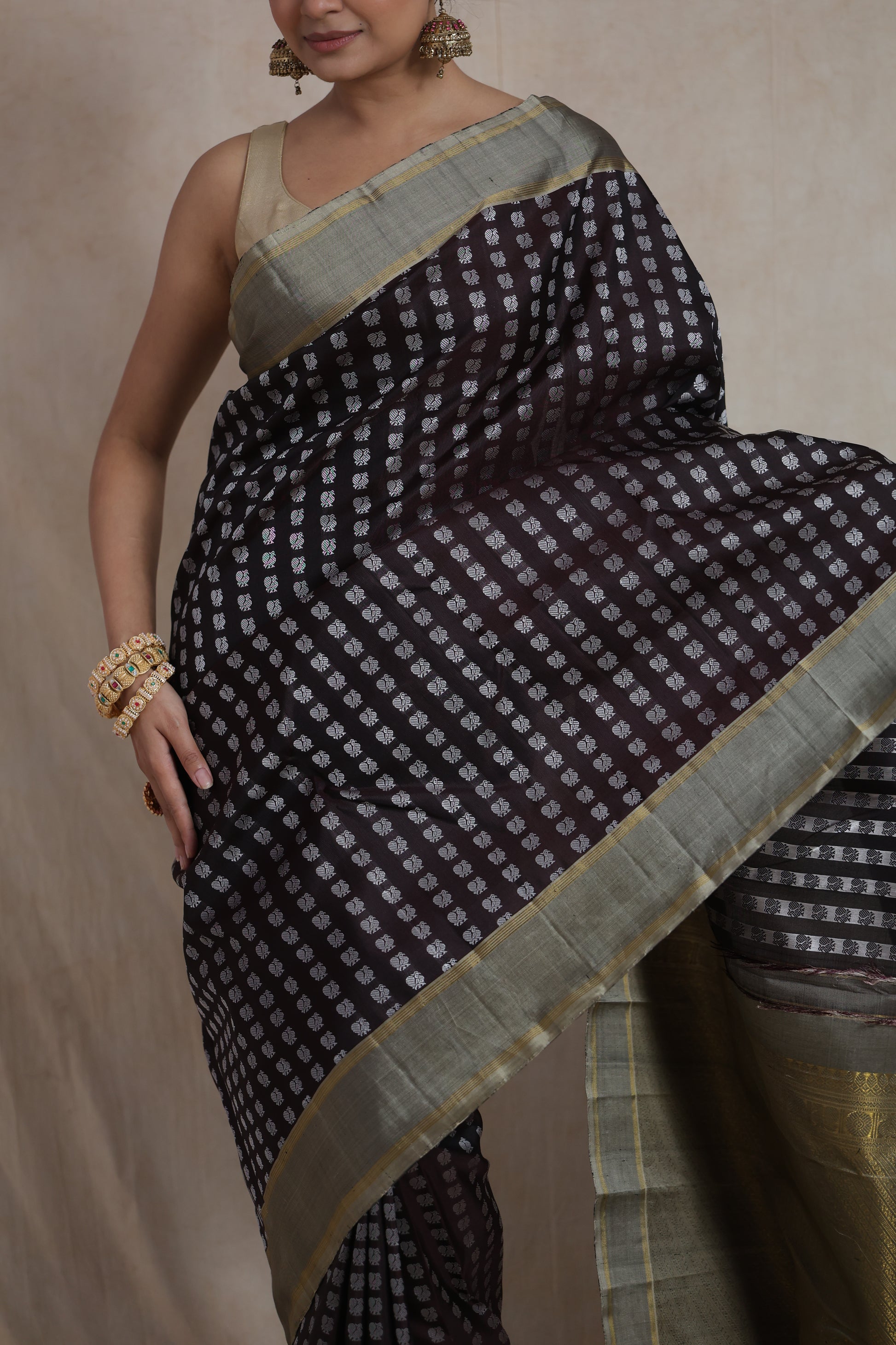 Detailed drape view of brown Kanjivaram silk saree with silver motifs
