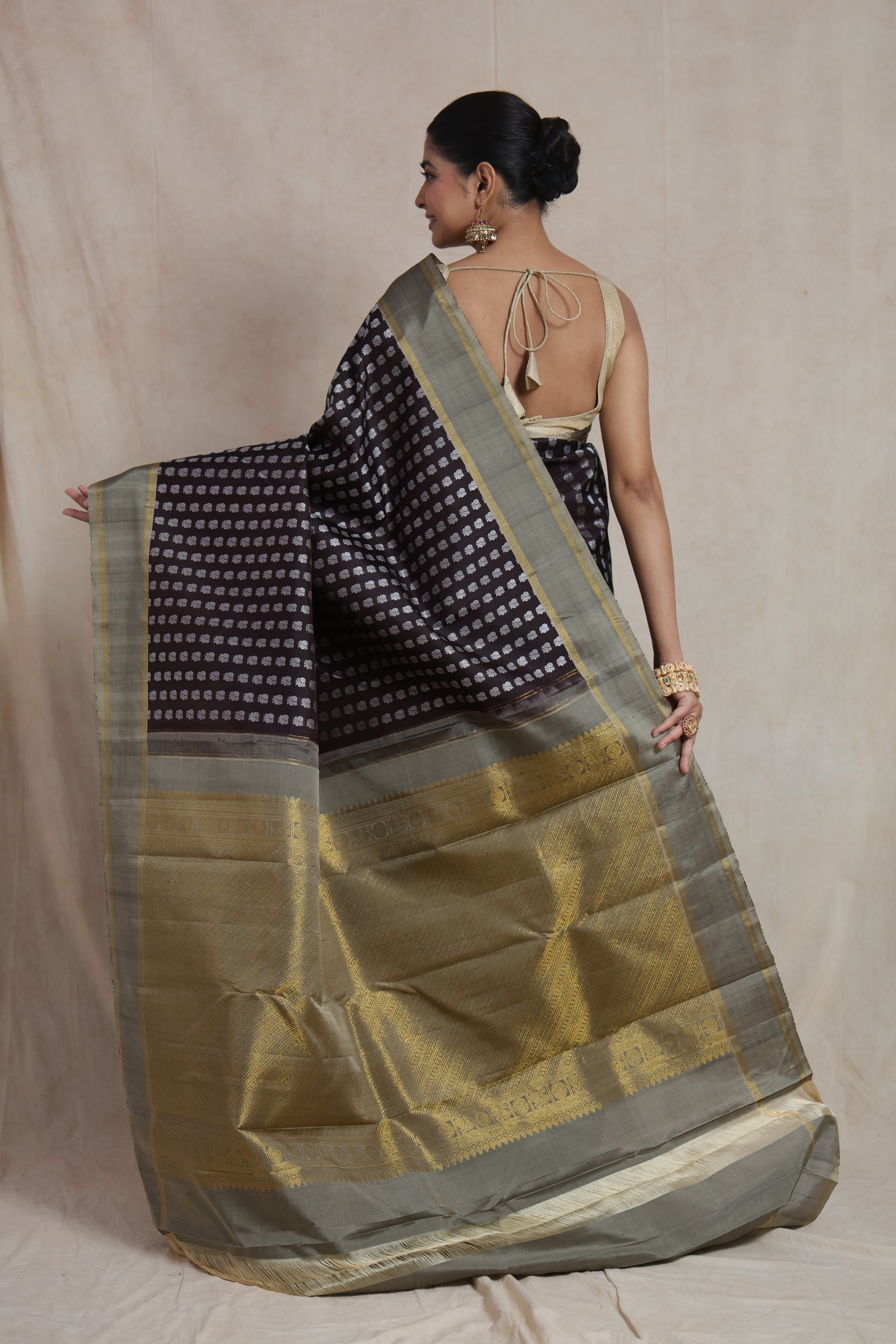 Detailed drape view of brown Kanjivaram silk saree with silver motifs