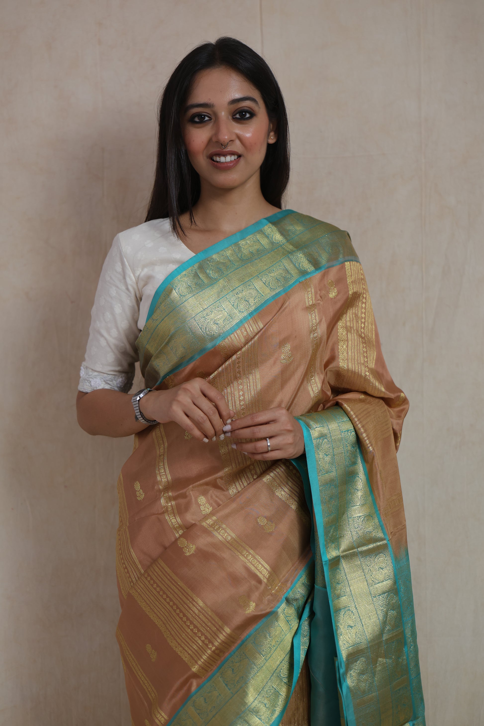 Front drape view of Venkatagiri silk saree in champagne gold with elegant woven detailing