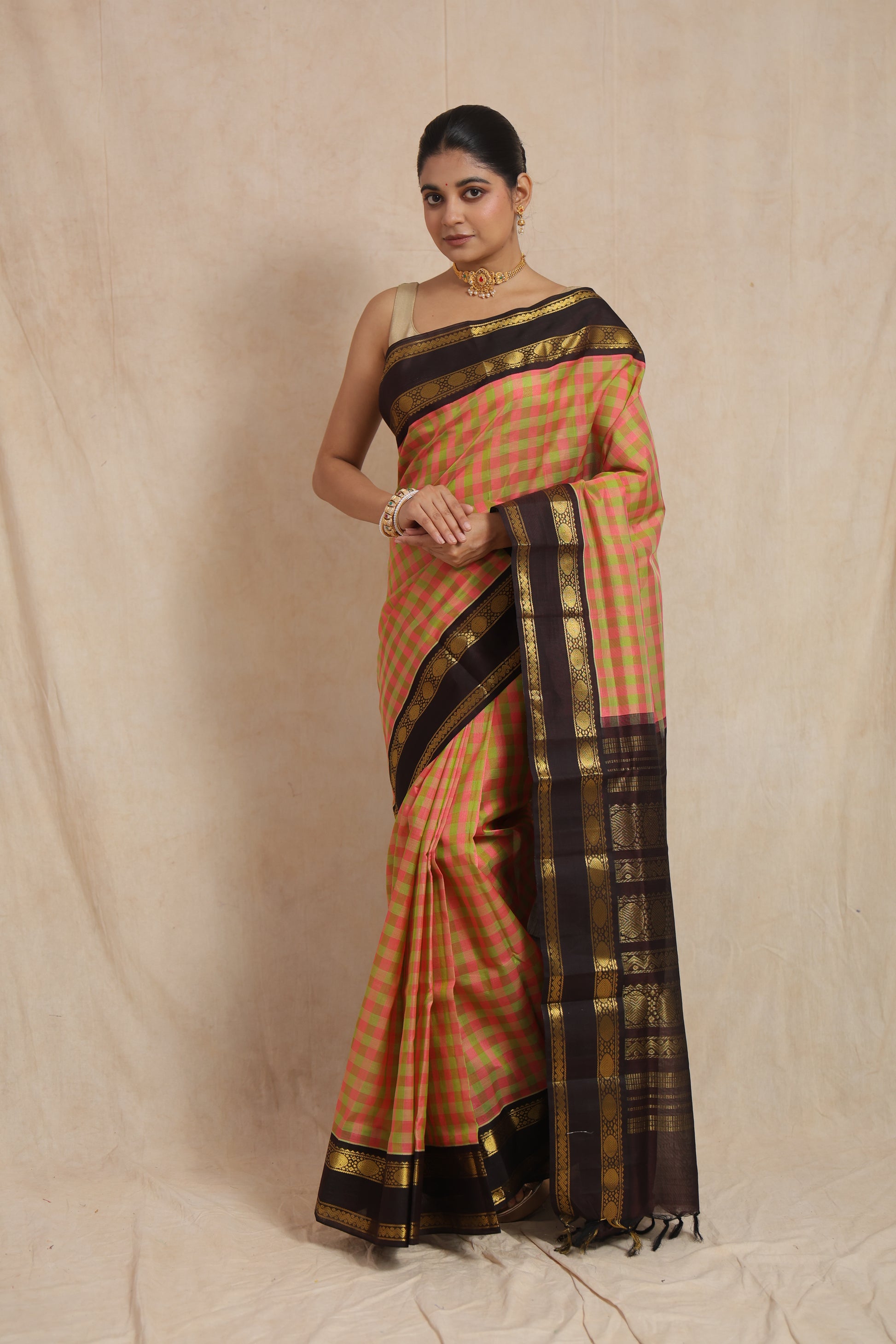 Full view of pastel pink and olive checked Kanchipuram Sico saree with black border
