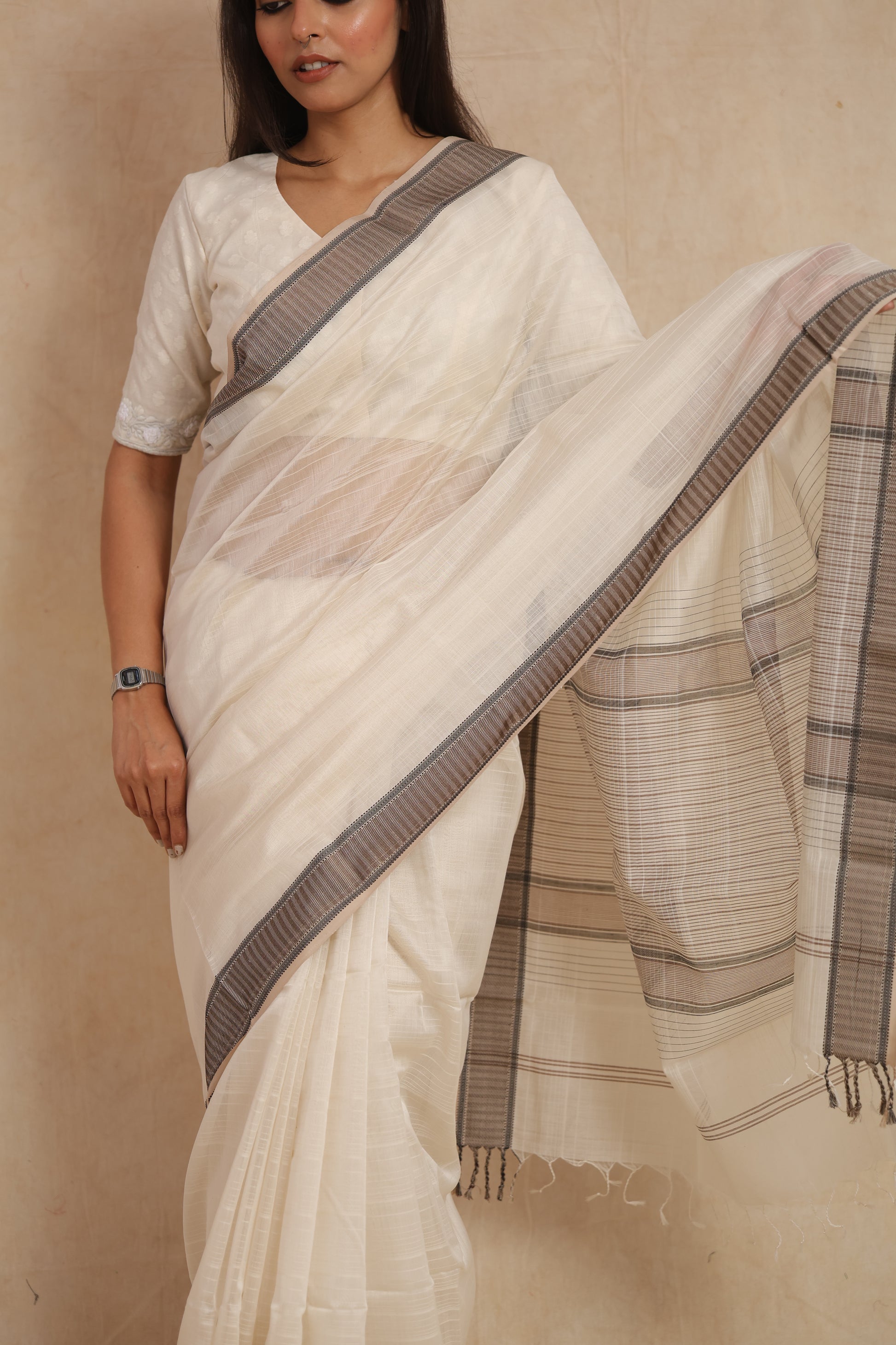 Close-up of ivory white Maheshwari silk tissue saree with ash grey border detailing