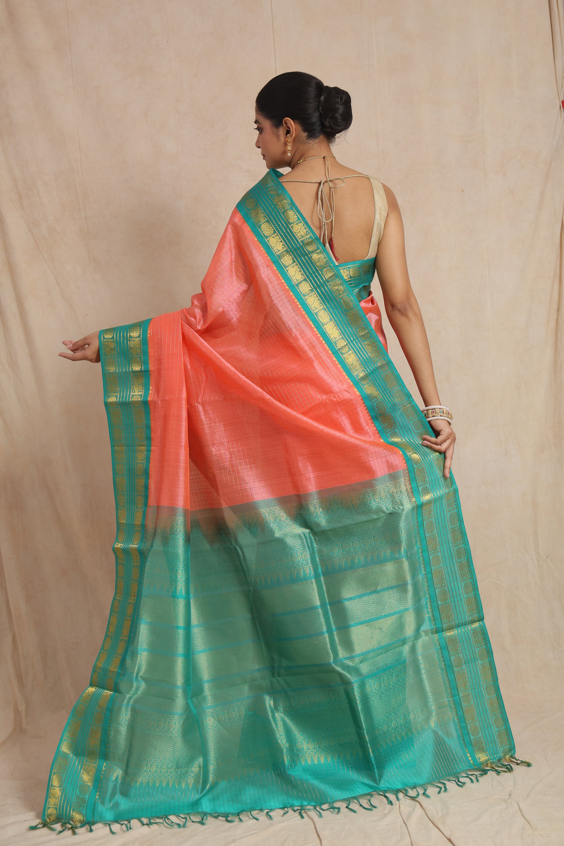 Back view of coral peach Kanchipuram Sico saree with aqua green pallu