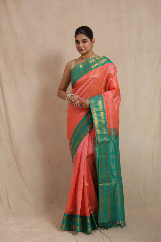 Full front look of coral peach Kanchipuram Sico saree on model