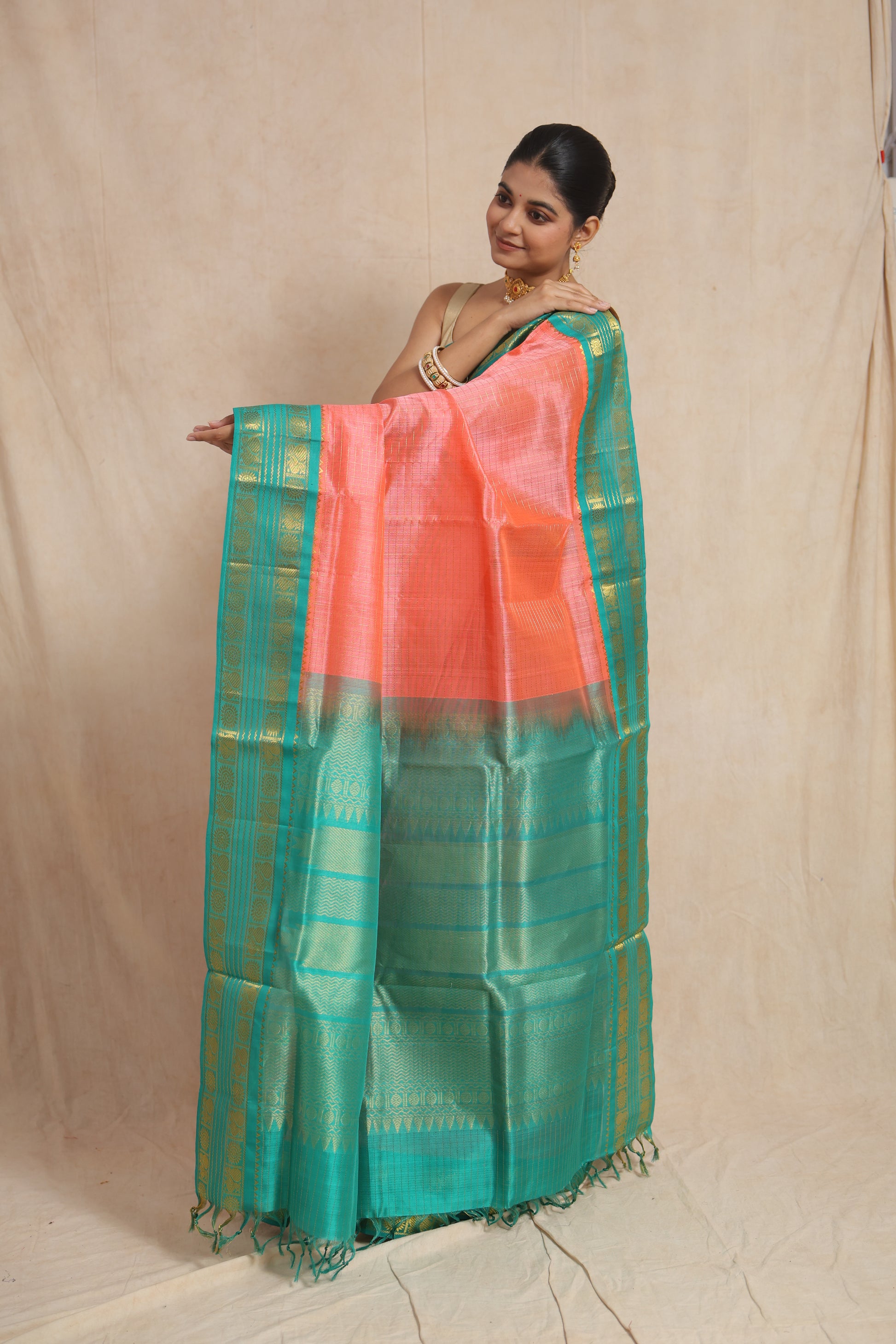 Detailed pallu of coral peach Kanchipuram Sico saree with woven border