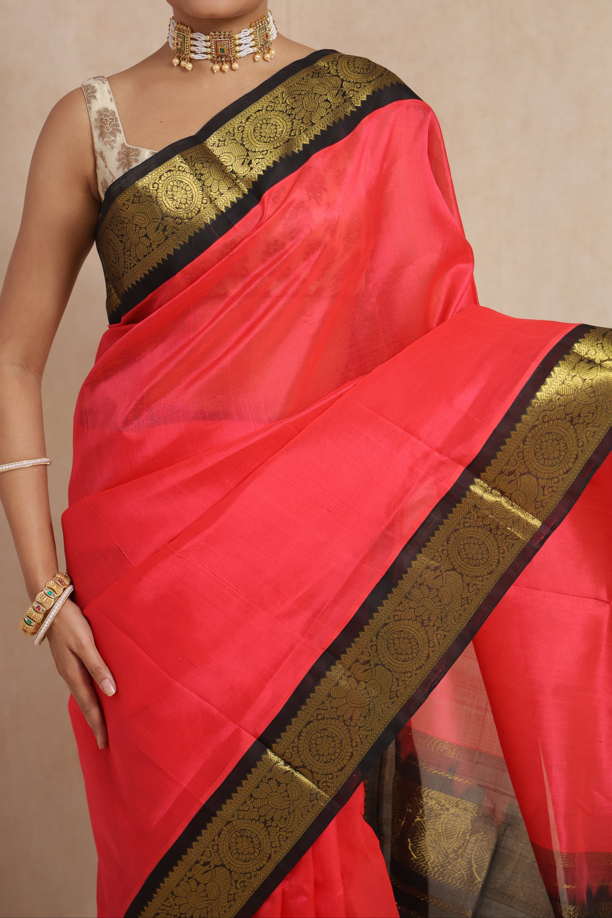 Detailed border view of coral pink Kanchipuram Sico saree with antique gold zari weaving