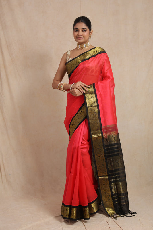 Full view of coral pink Kanchipuram Sico saree with black antique gold border