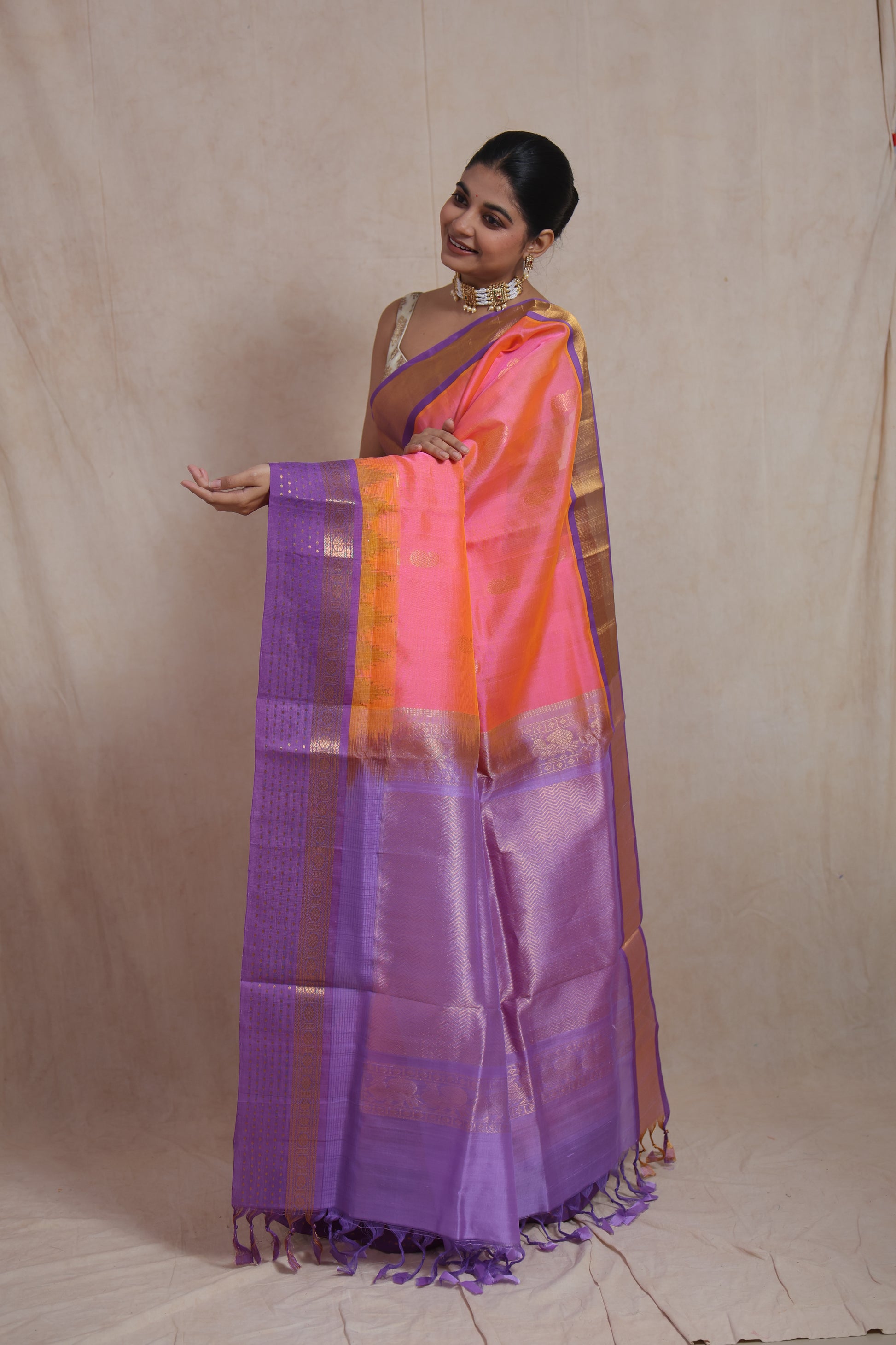 Coral pink Kanchipuram silk cotton saree with rich lavender zari pallu