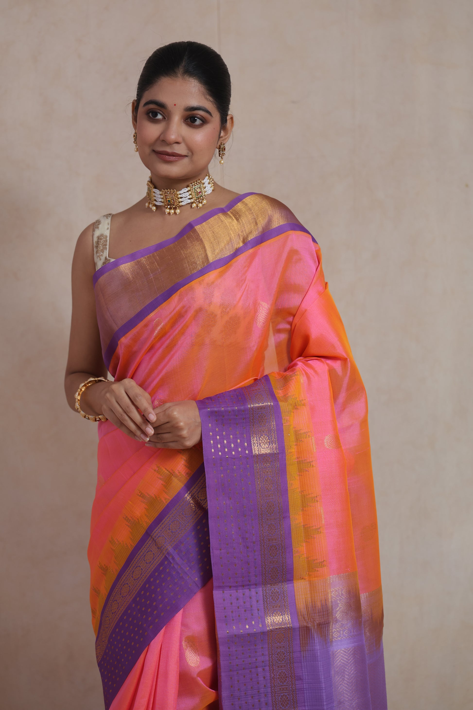 Closeup view of coral pink silk cotton saree with lavender woven border