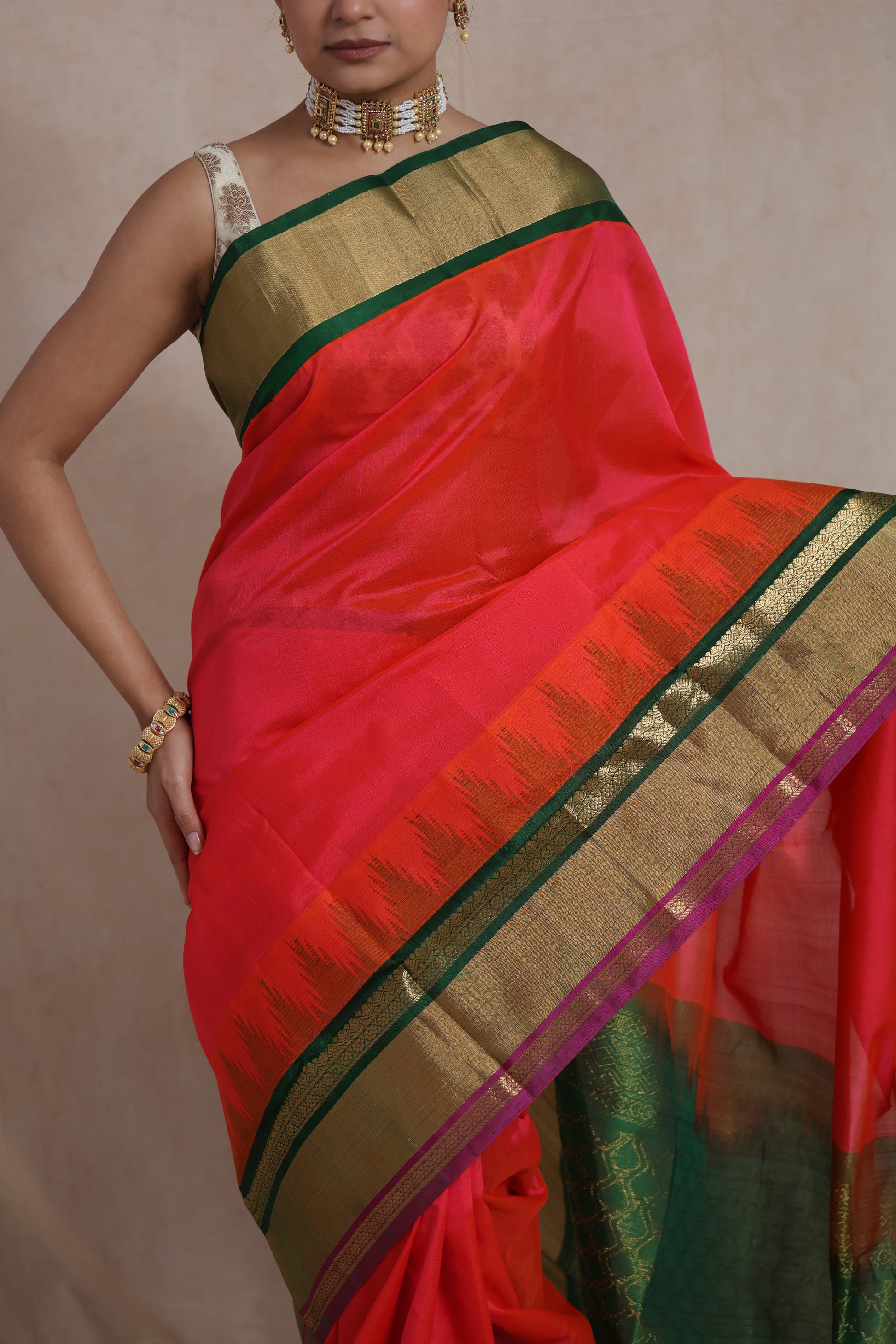 Detailed pallu view of coral red Kanchipuram silk cotton saree