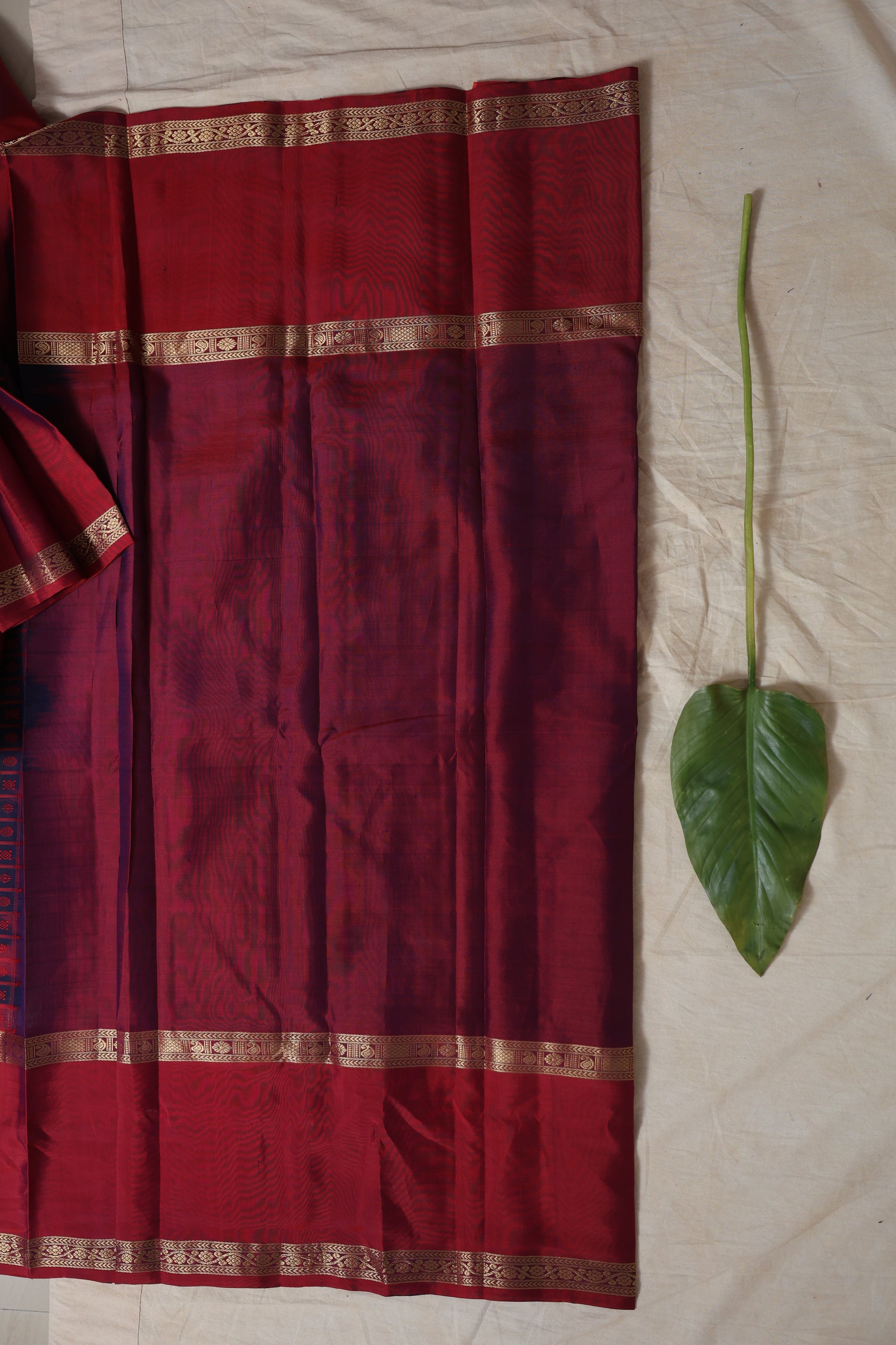Detailed body design of crimson Kanjivaram silk saree with zari borders